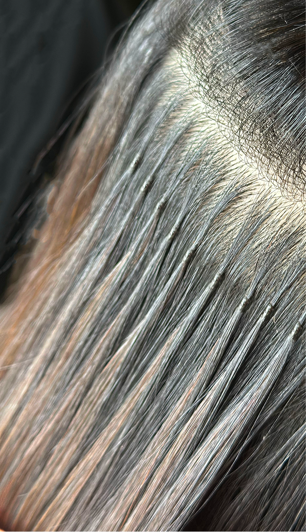 back of woman's head showing k-tip hair extensions