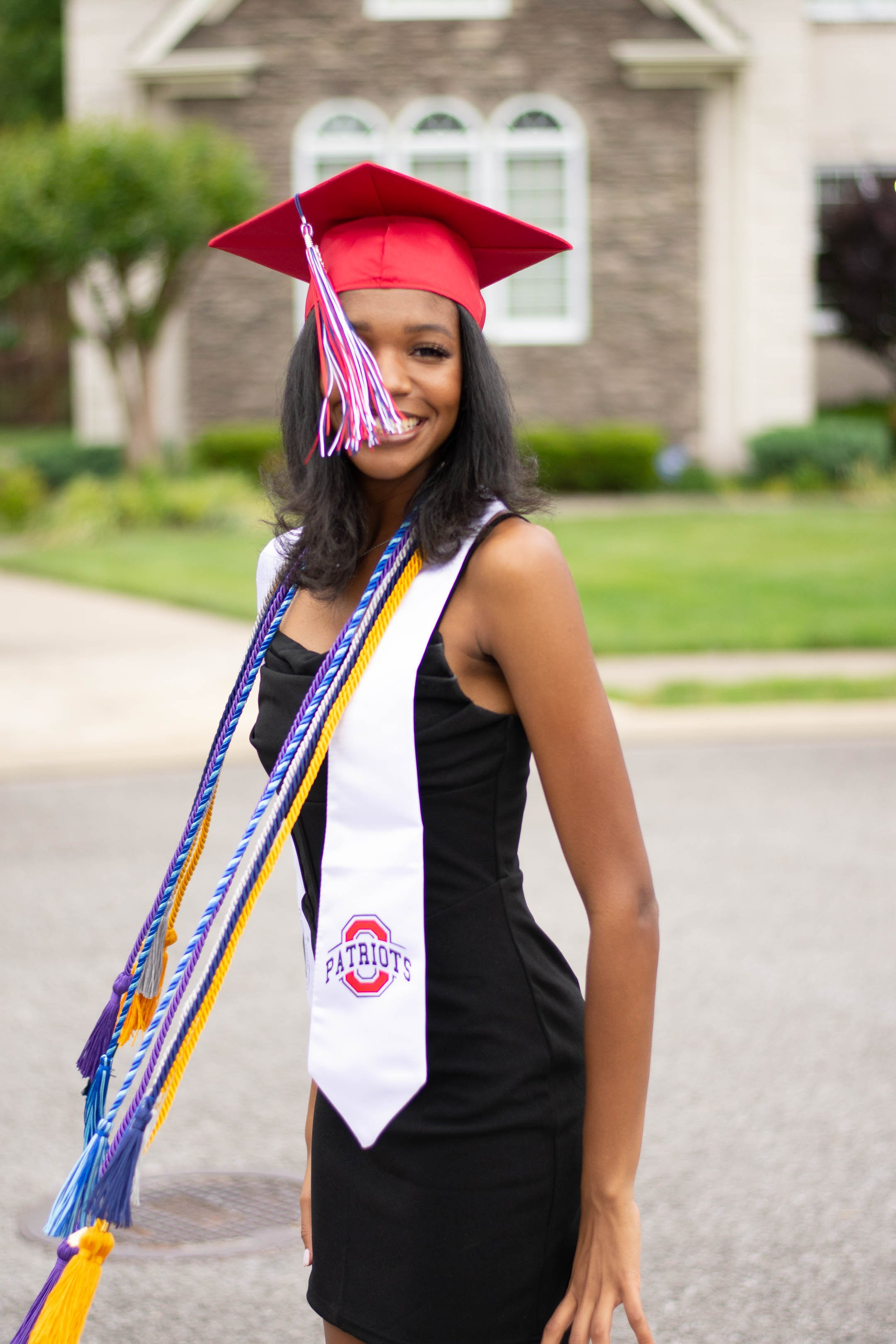 local senior portrait session cap, gown, and tassels 