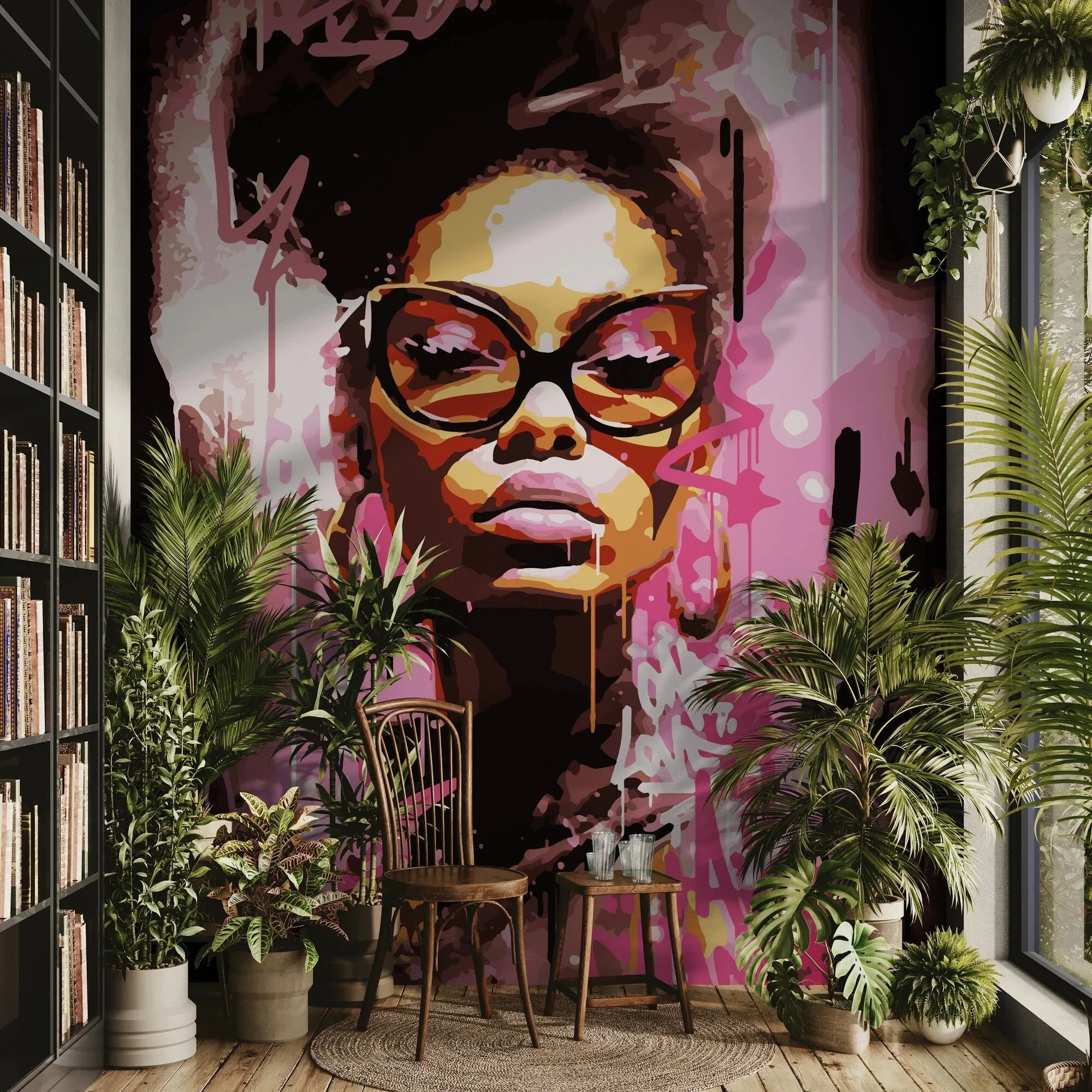 Stylish interior with a large colorful portrait of a woman wearing glasses on a pink background, surrounded by green plants, bookshelves, and natural light.