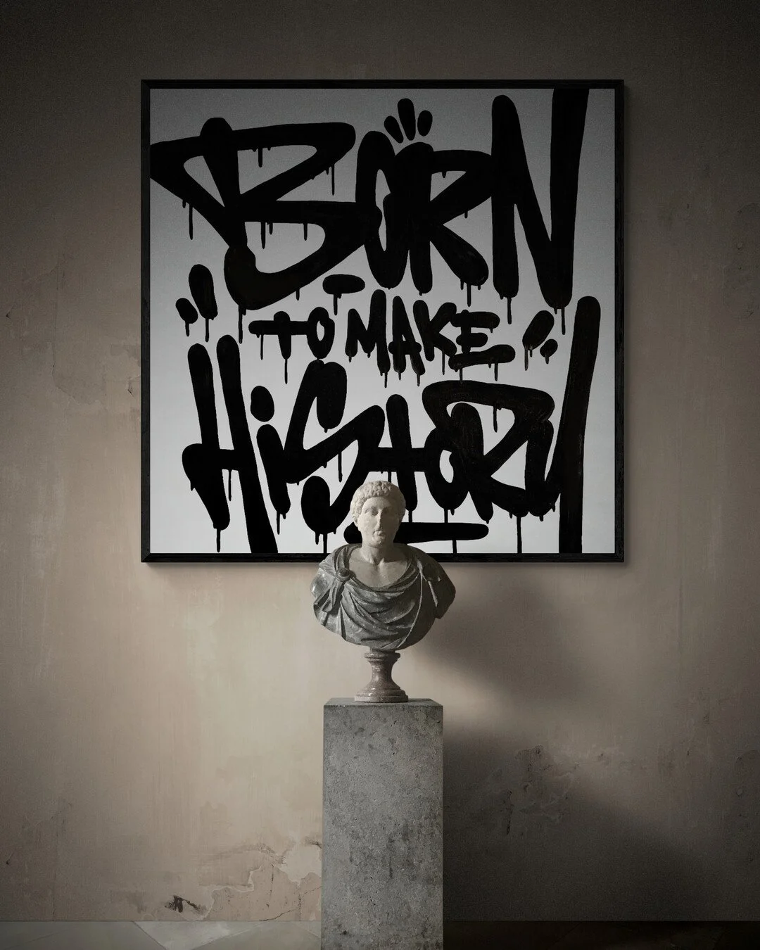 Modern wall art with graffiti text that says 'BORN TO MAKE HISMORY', with a classical bust statue in front on a stone pedestal.