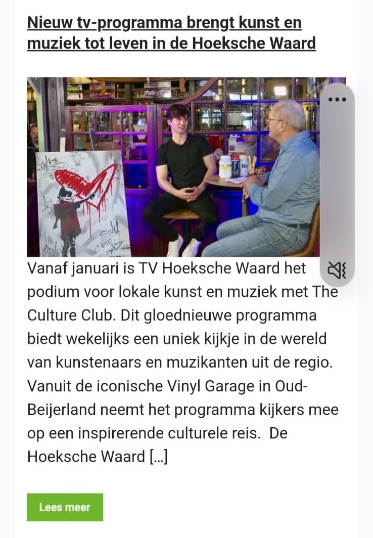 A newspaper article featuring a photo of two men sitting and talking at a table inside a venue with colorful lighting. One man is young, wearing a black shirt, and the other is older, dressed in a gray shirt. To the left, there is graffiti-style artwork.