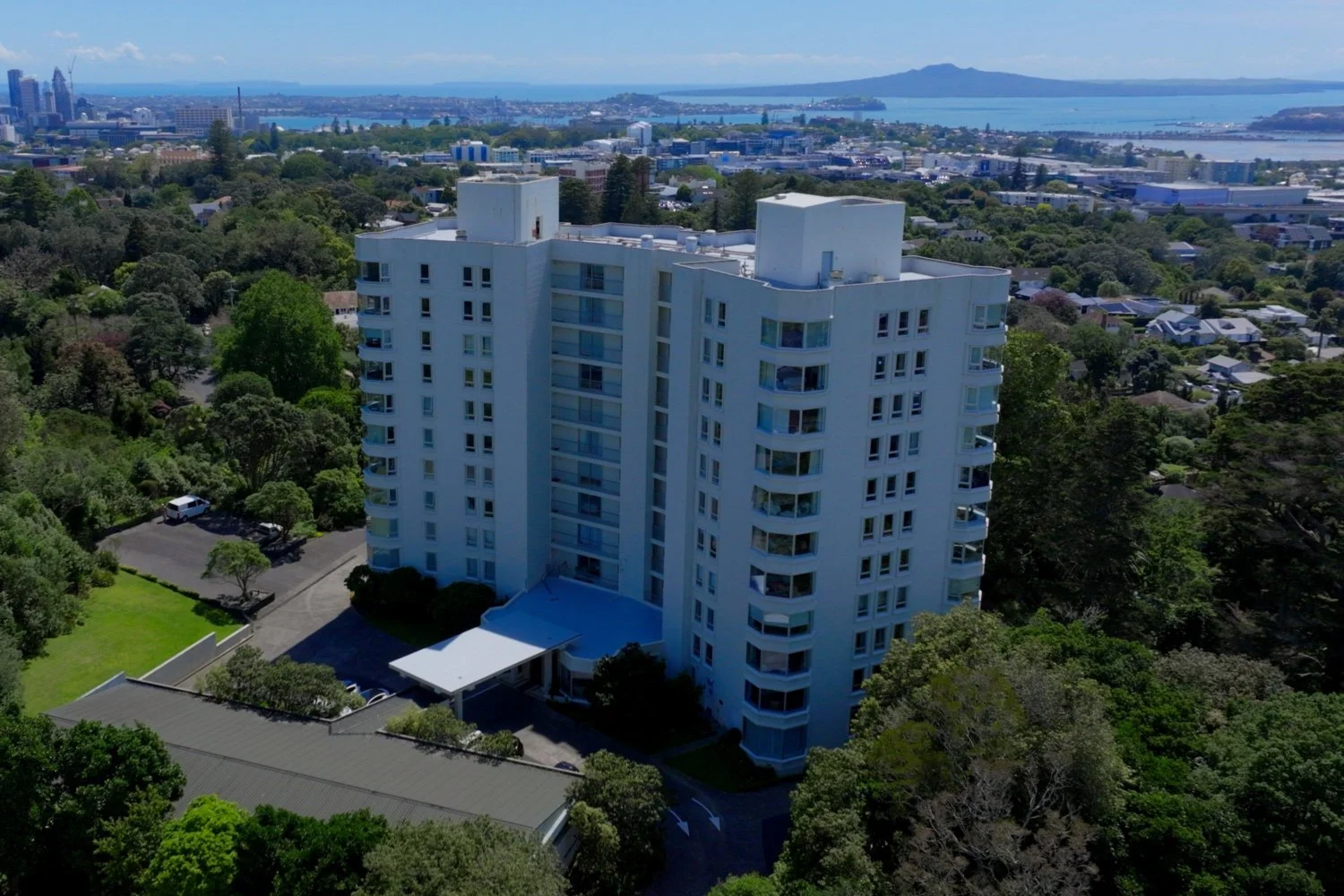 The Pines Apartments viewed from a drone, with Rangitoto and Auckland city in the background.