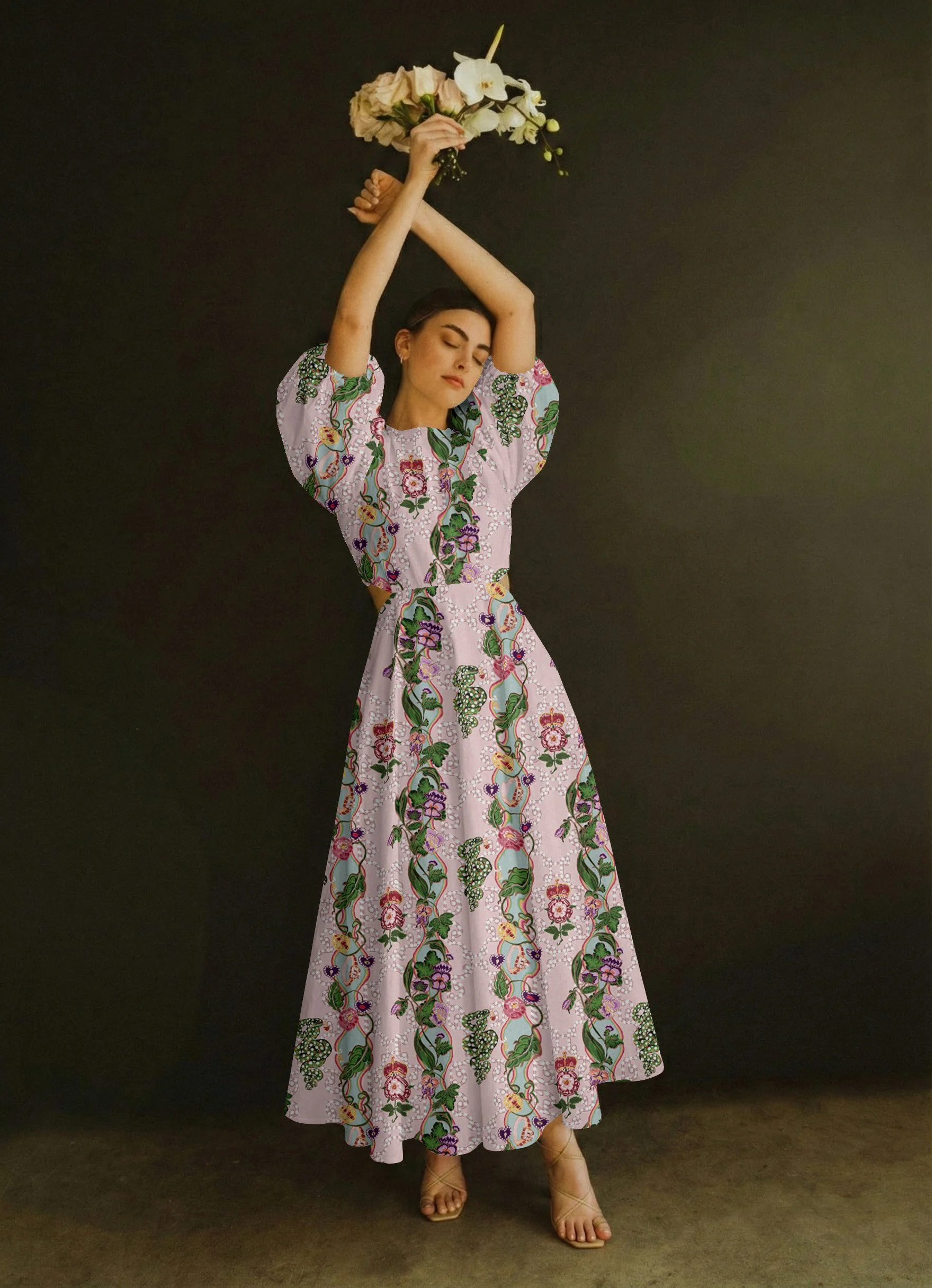 Woman in a floral dress holding a bouquet of white flowers above her head, standing against a dark background.