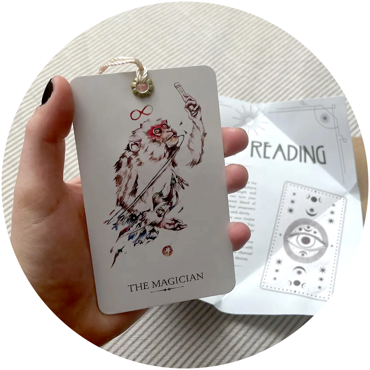 tarot card bookmark held in hand, printed interpretation of blind tarot reading in background.