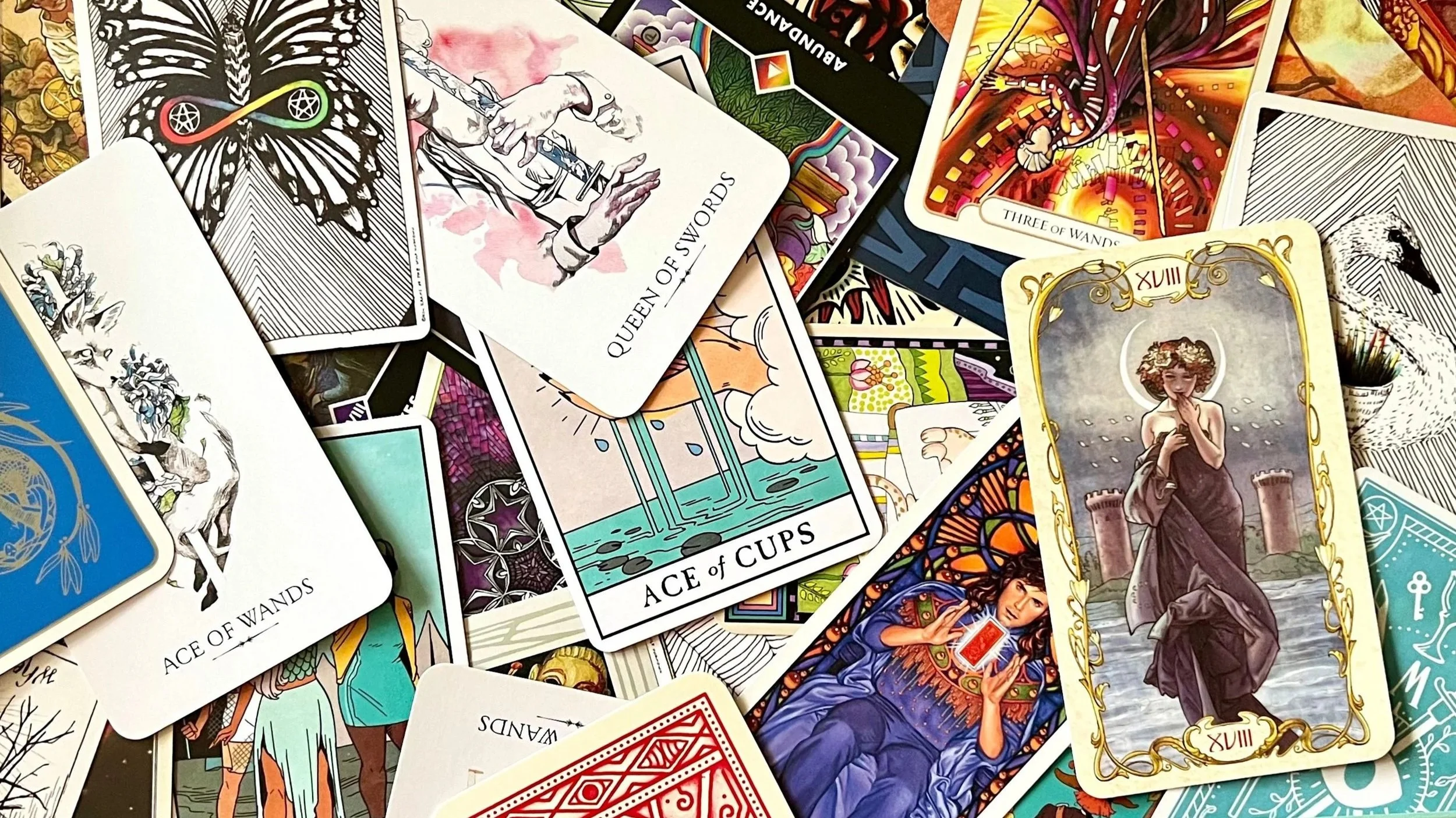 tarot cards from multiple decks spread face-up