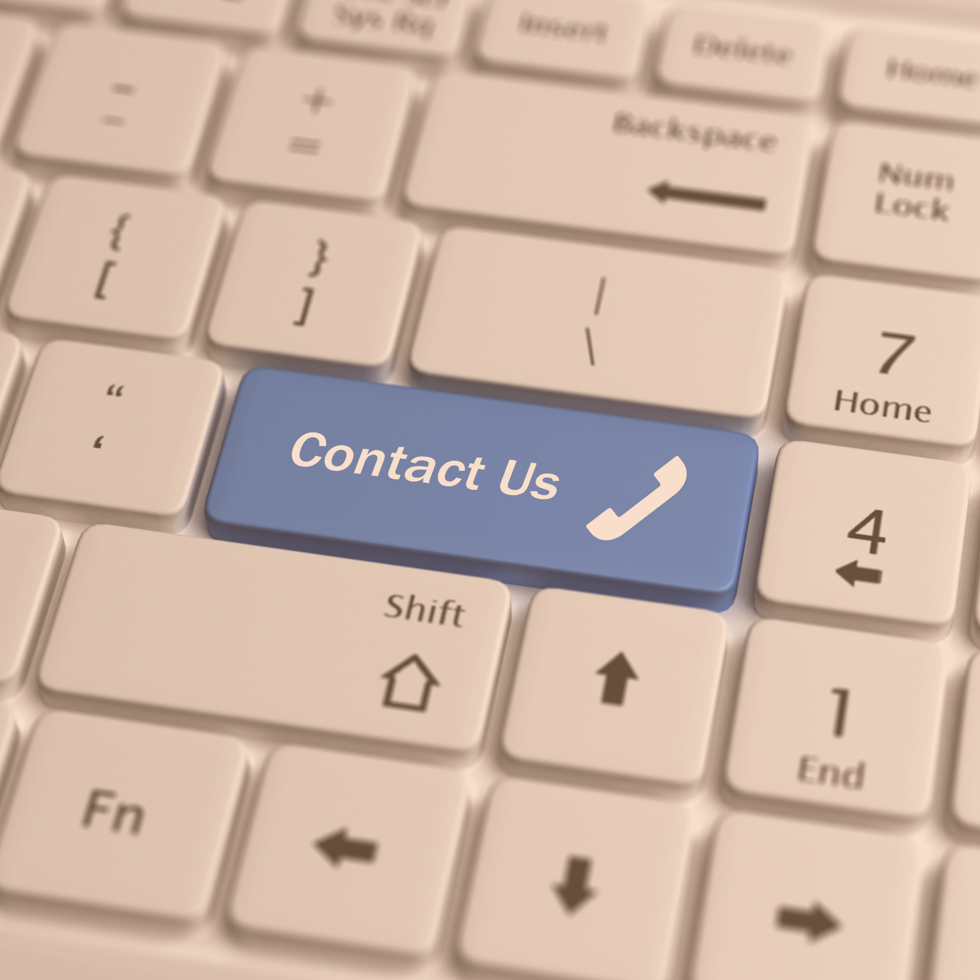 A computer keyboard with a blue key labeled "Contact Us" and a phone icon, indicating a contact or customer service option.