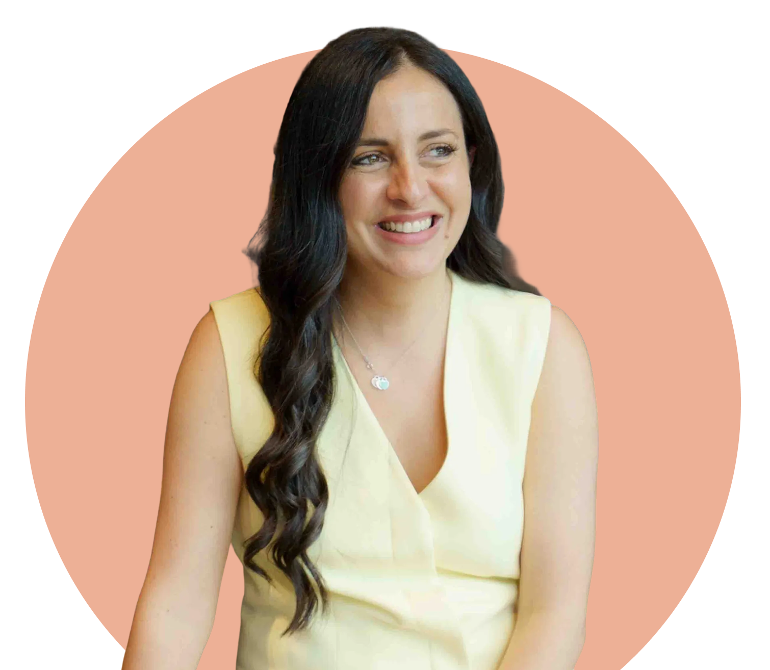 A woman with long dark hair is smiling, wearing a sleeveless yellow dress and a necklace, sitting against a pink circle background.