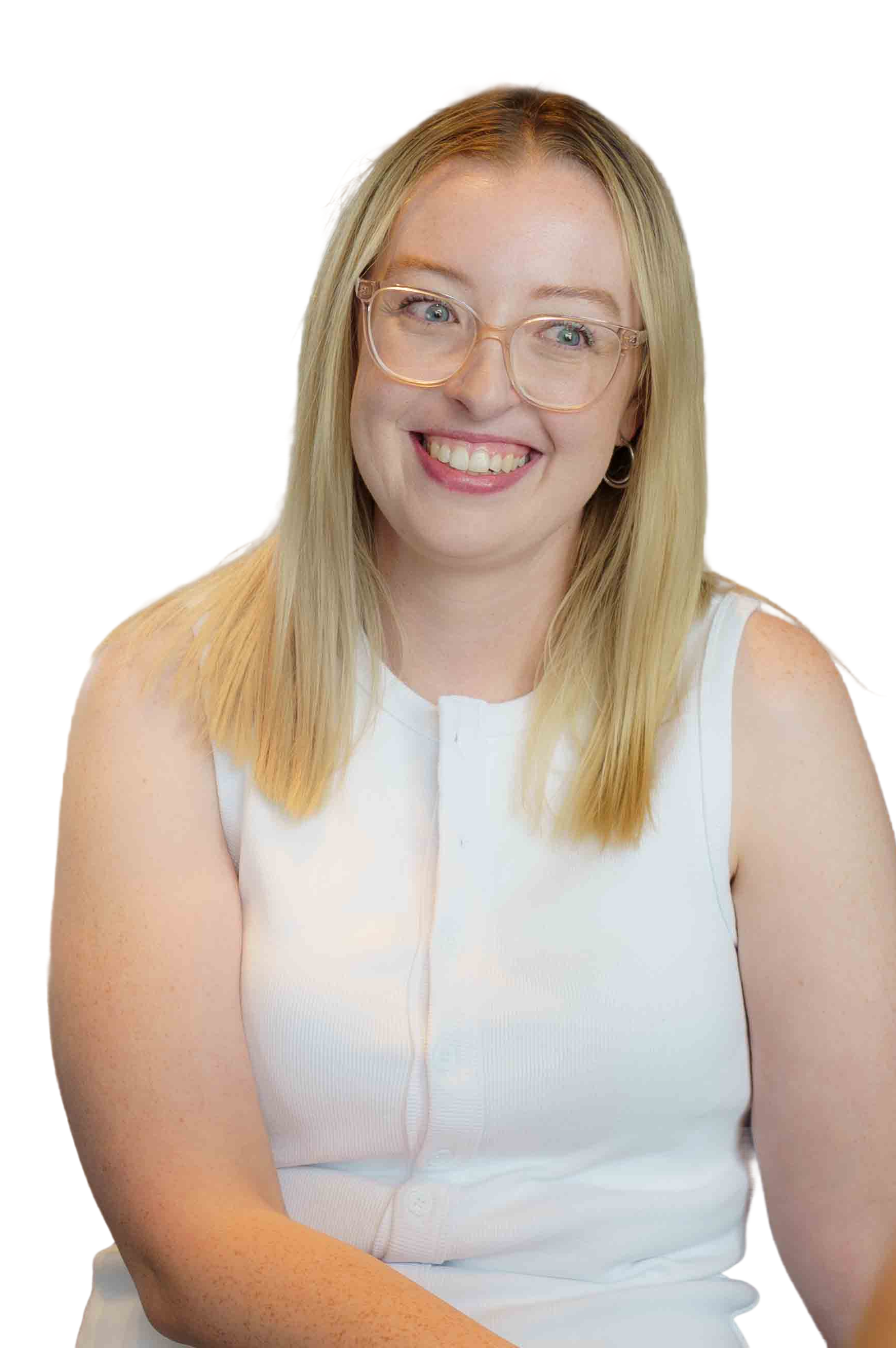 Portrait of a woman with blonde hair, wearing glasses and a white sleeveless top, smiling in front of a background with red and black sections.