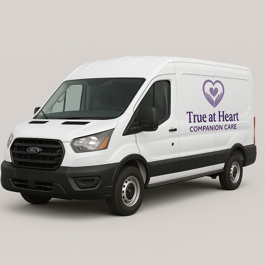 A white Ford cargo van with a purple heart-shaped logo and the text "True at Heart Companion Care" on the side.