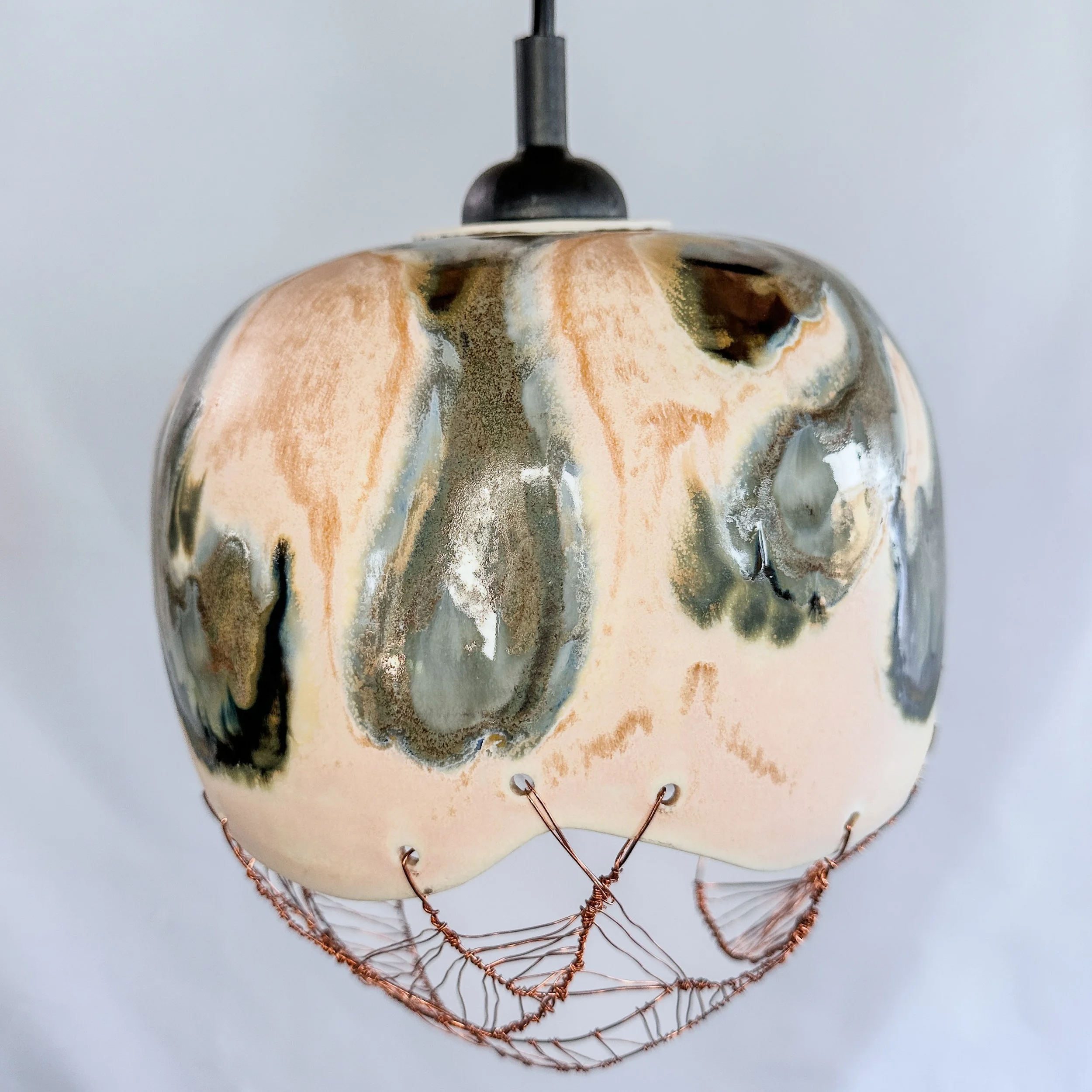 Handmade ceramic pendant lamp shade photographed in studio light