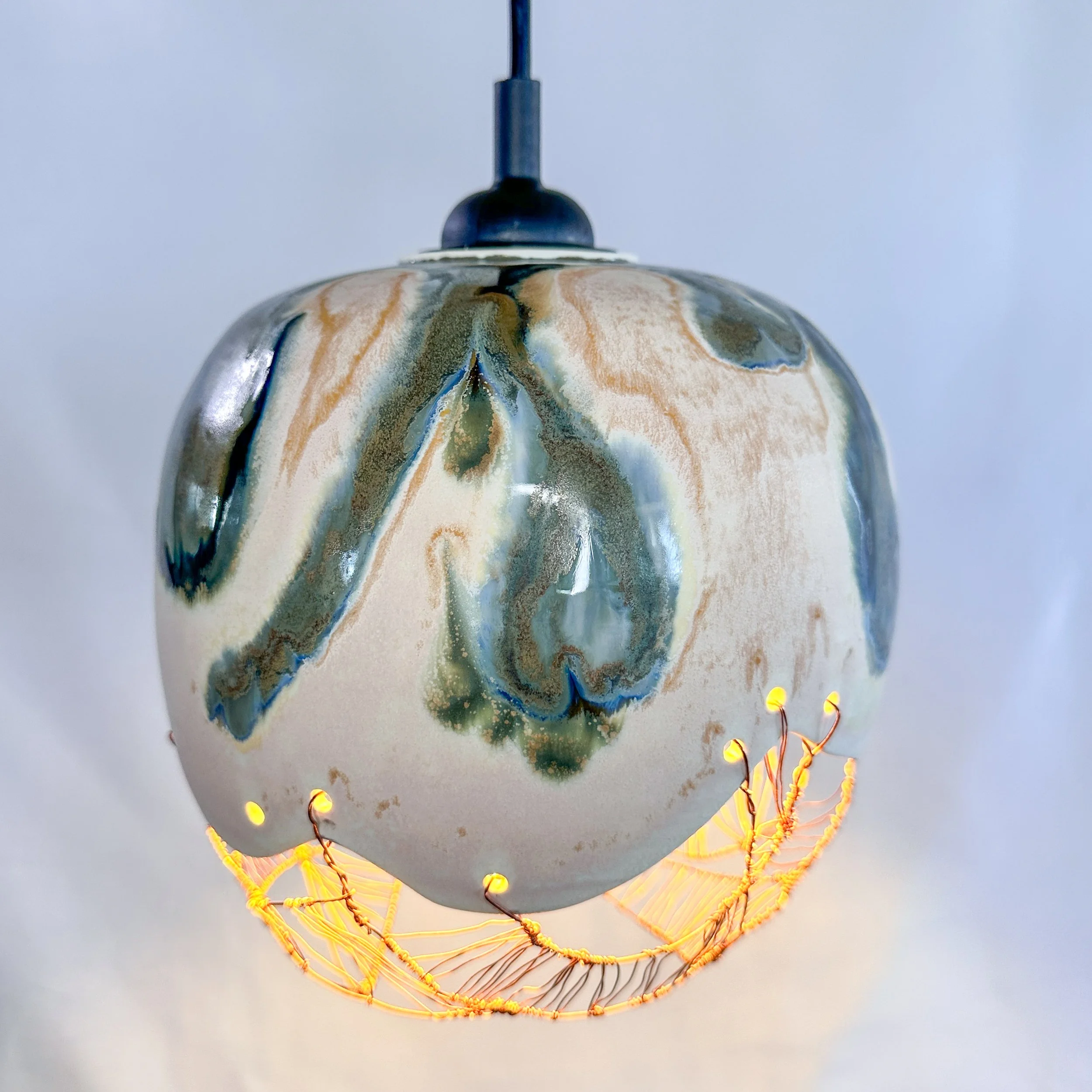 Wheel-thrown ceramic pendant lamp shade with glazed finish
