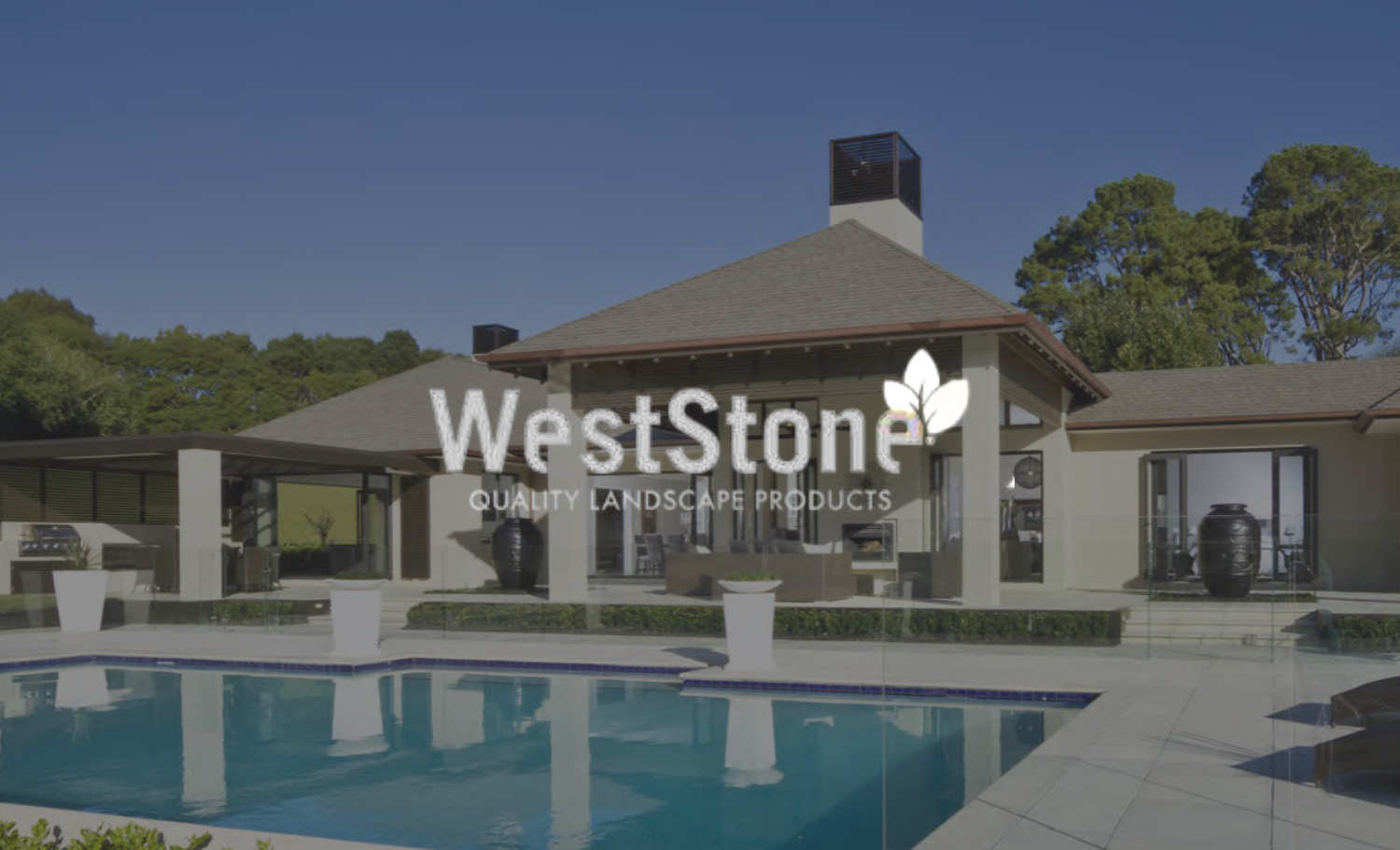A backyard with a swimming pool in front of a modern house, surrounded by trees. The house has a patio area with outdoor furniture. The brand 'WestStone' and the text 'Quality Landscape Products' are overlaid on the image.