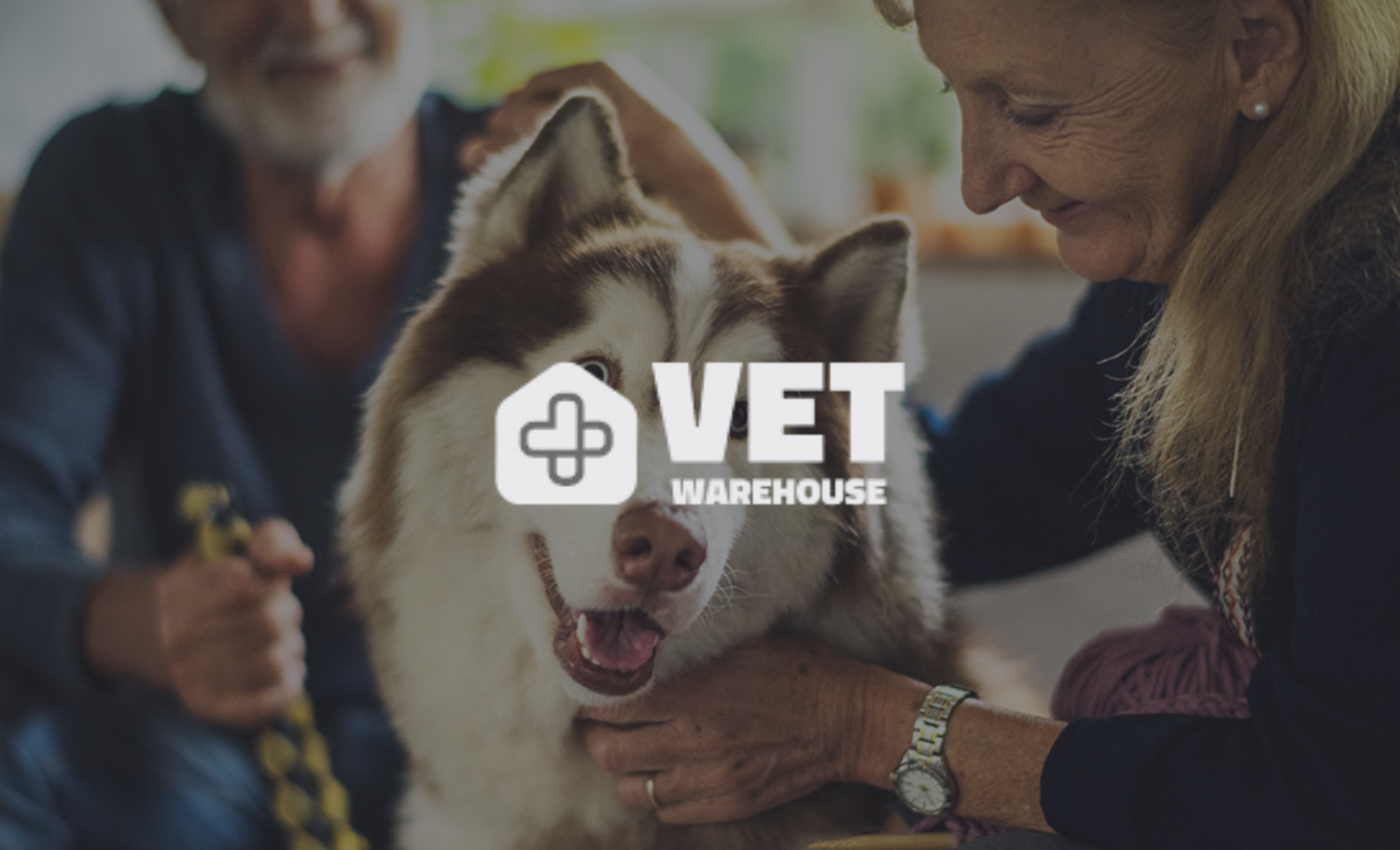 Two women and a Siberian Husky service dog at a veterinary clinic, with the message 'VET WAREHOUSE' overlaying the image.