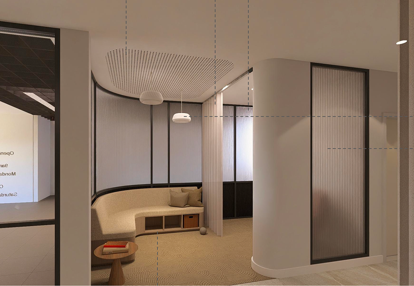 Modern office corner with beige curved seating, small wooden side table with a book, gray cushions, and a ball on the carpet.