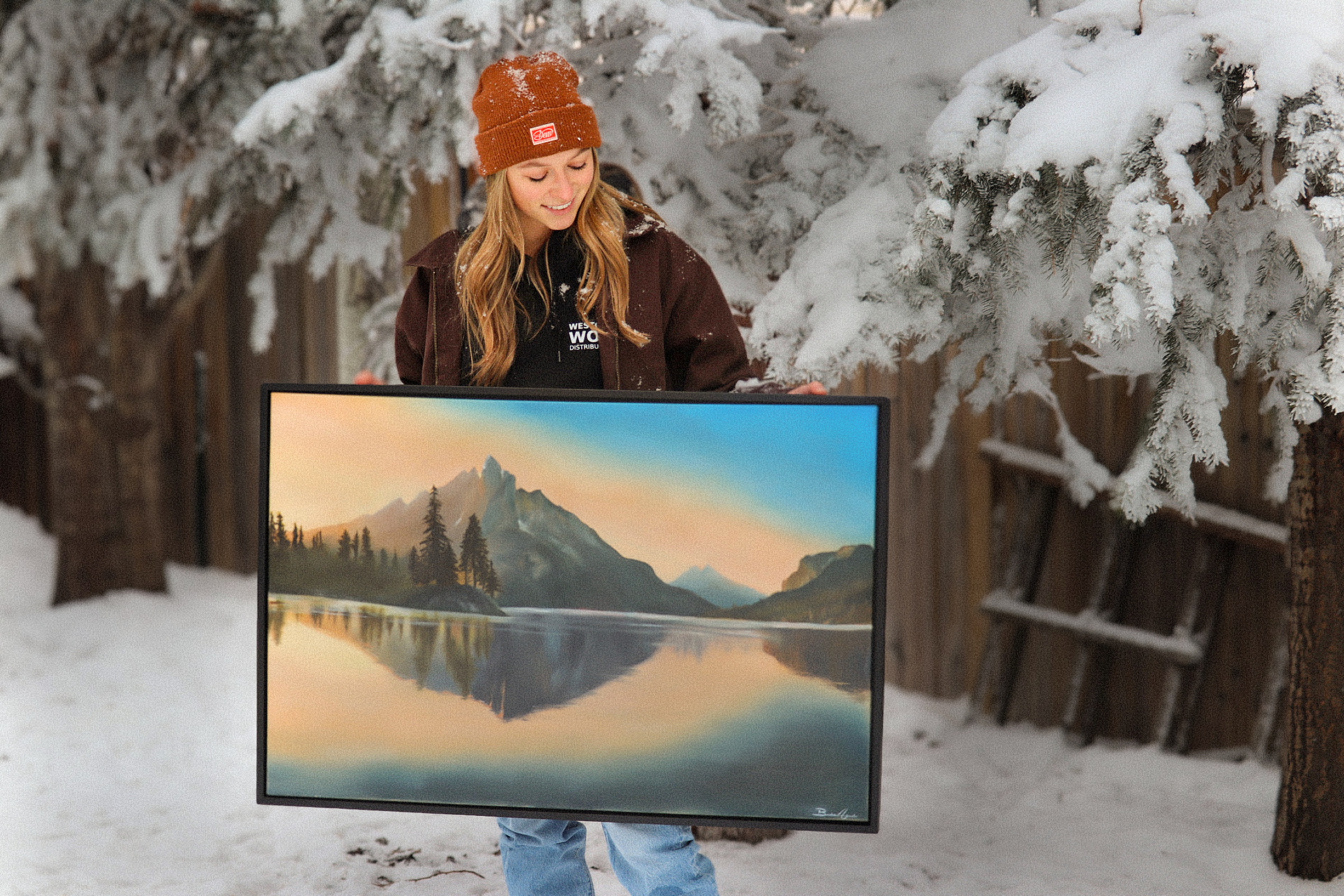A scenic landscape of mountains, trees, and a lake, mirrored in reflection.