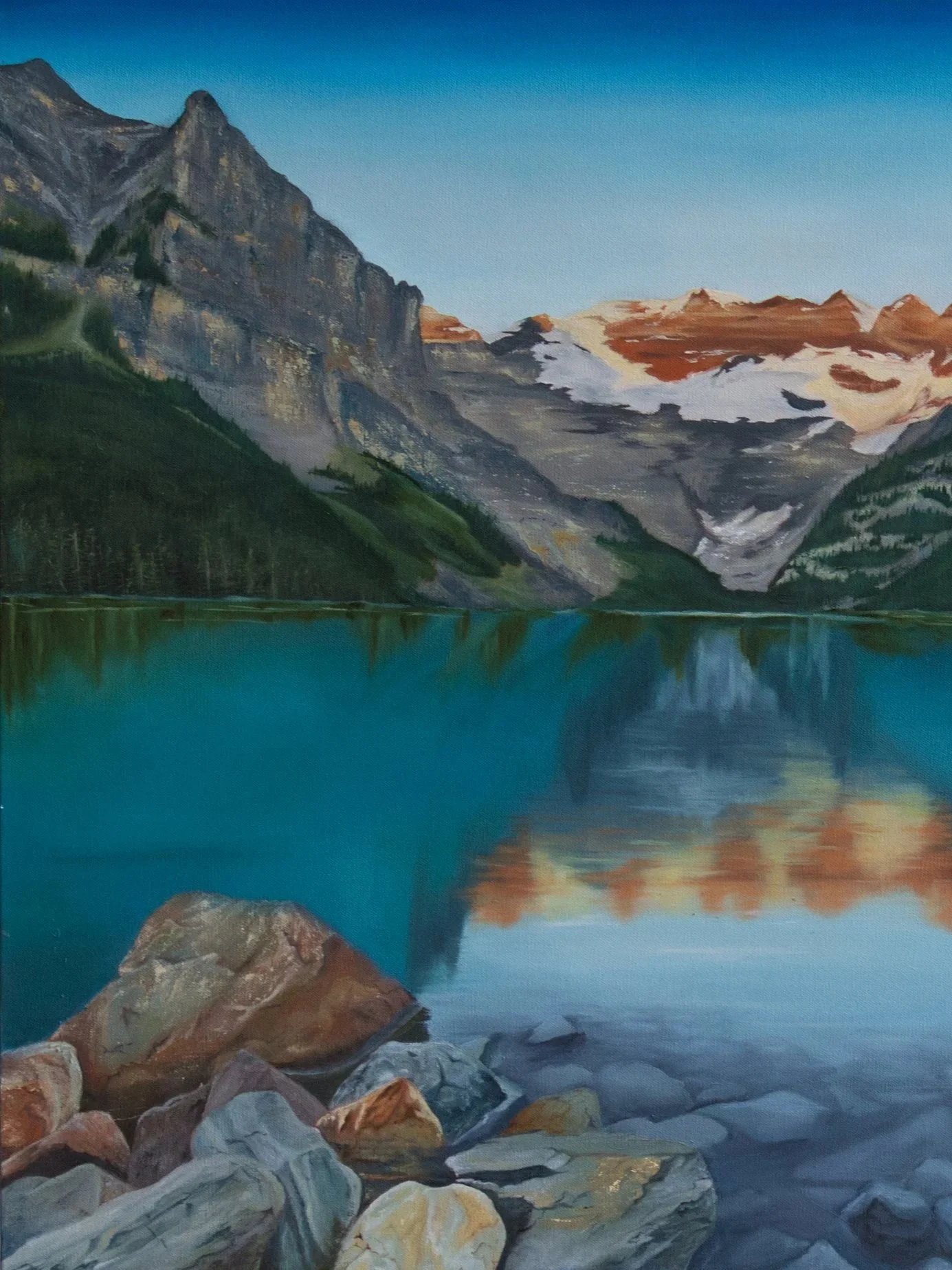 Painting of Lake Louise landscape with snow-capped peaks, green slopes, and a calm blue lake with rocks in the foreground.