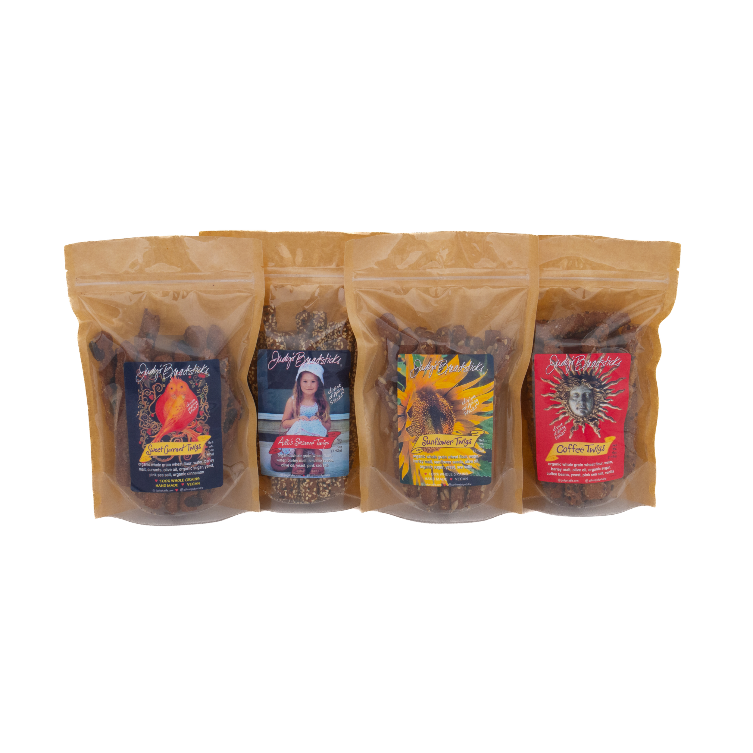 Front of 4 packs of Twigs product showing kraft bag. one of 4 flavors of breadsticks: Sweet Currant, Sunflower, Sesame & Coffee