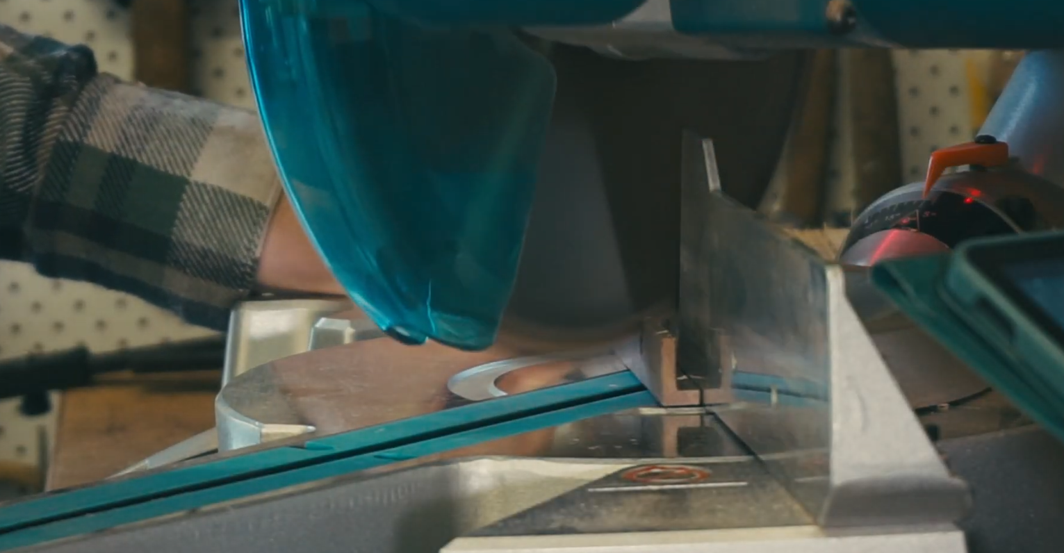 miter saw cutting miters on the picture frame