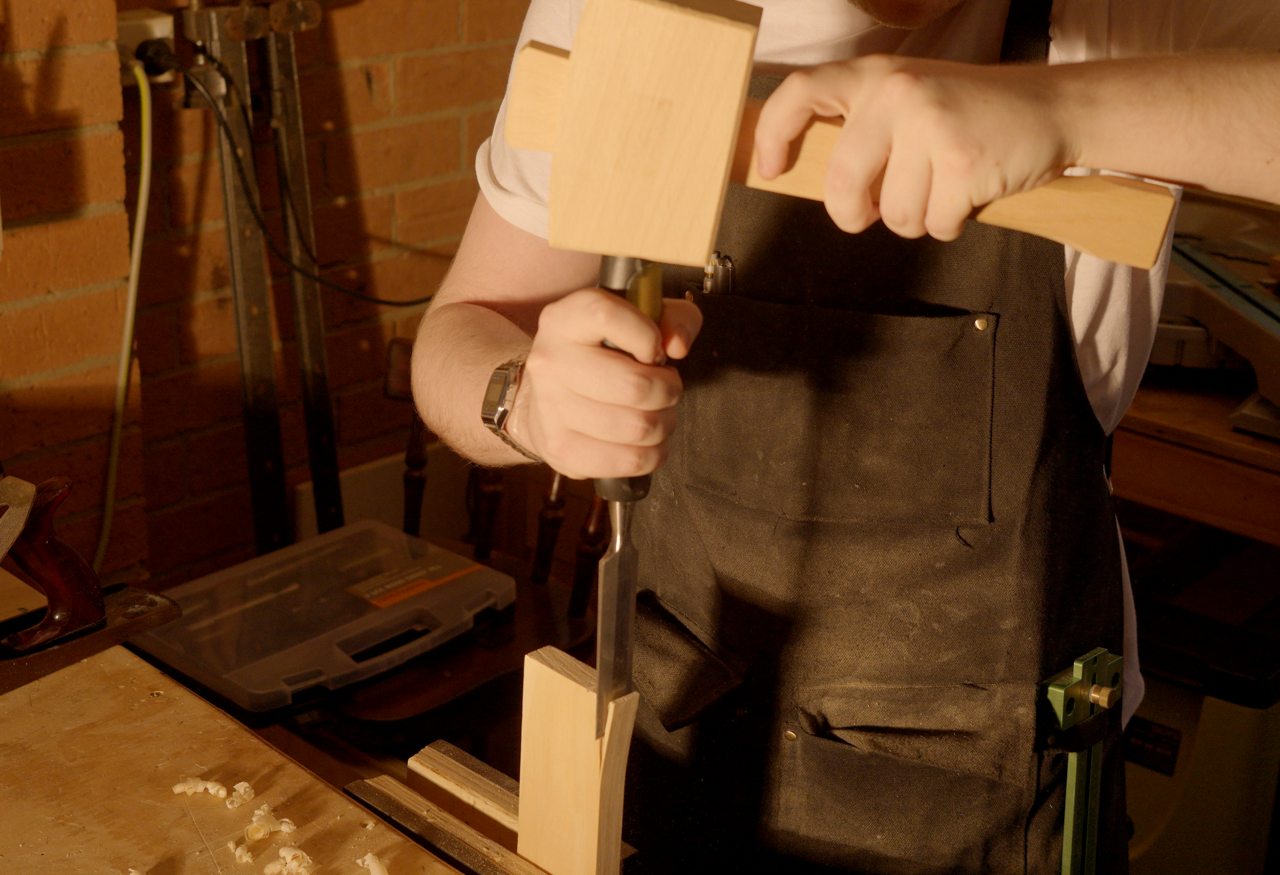 Hammering a chisel into wood