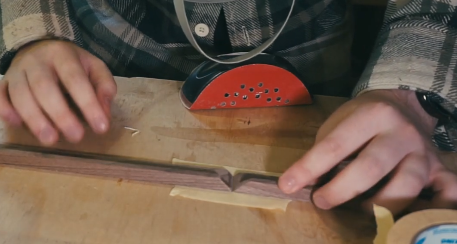setting the picture frame pieces up with masking tape for glue