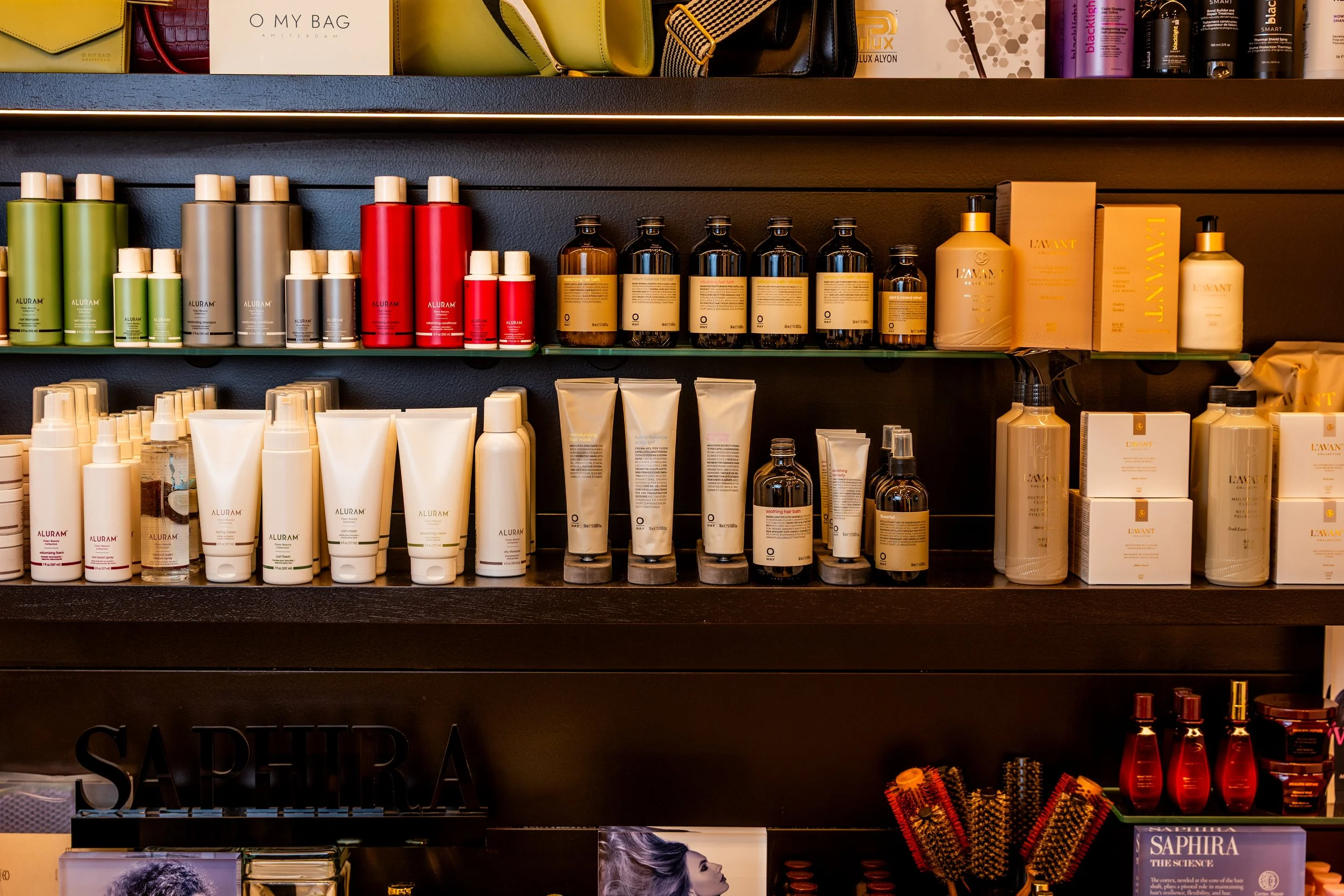 Shelves stocked with various hair and skincare products in bottles, jars, and boxes at a beauty salon or store.