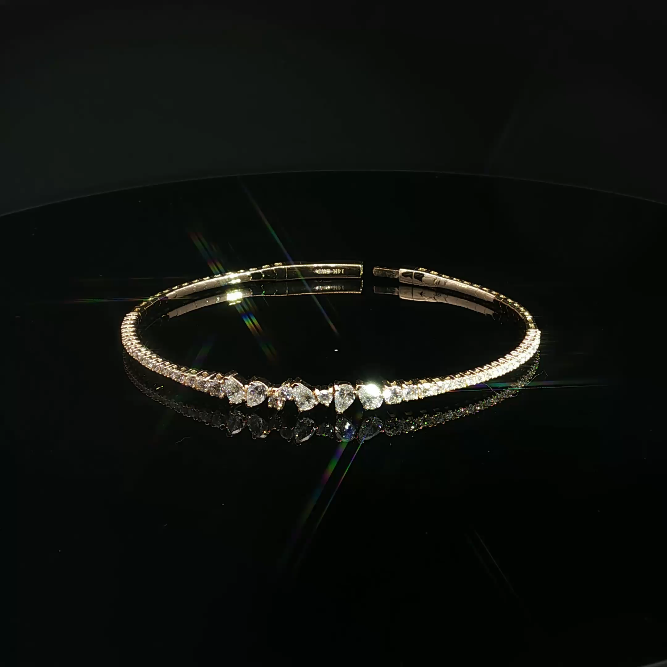 A close-up of a diamond bracelet set displayed on a black background.