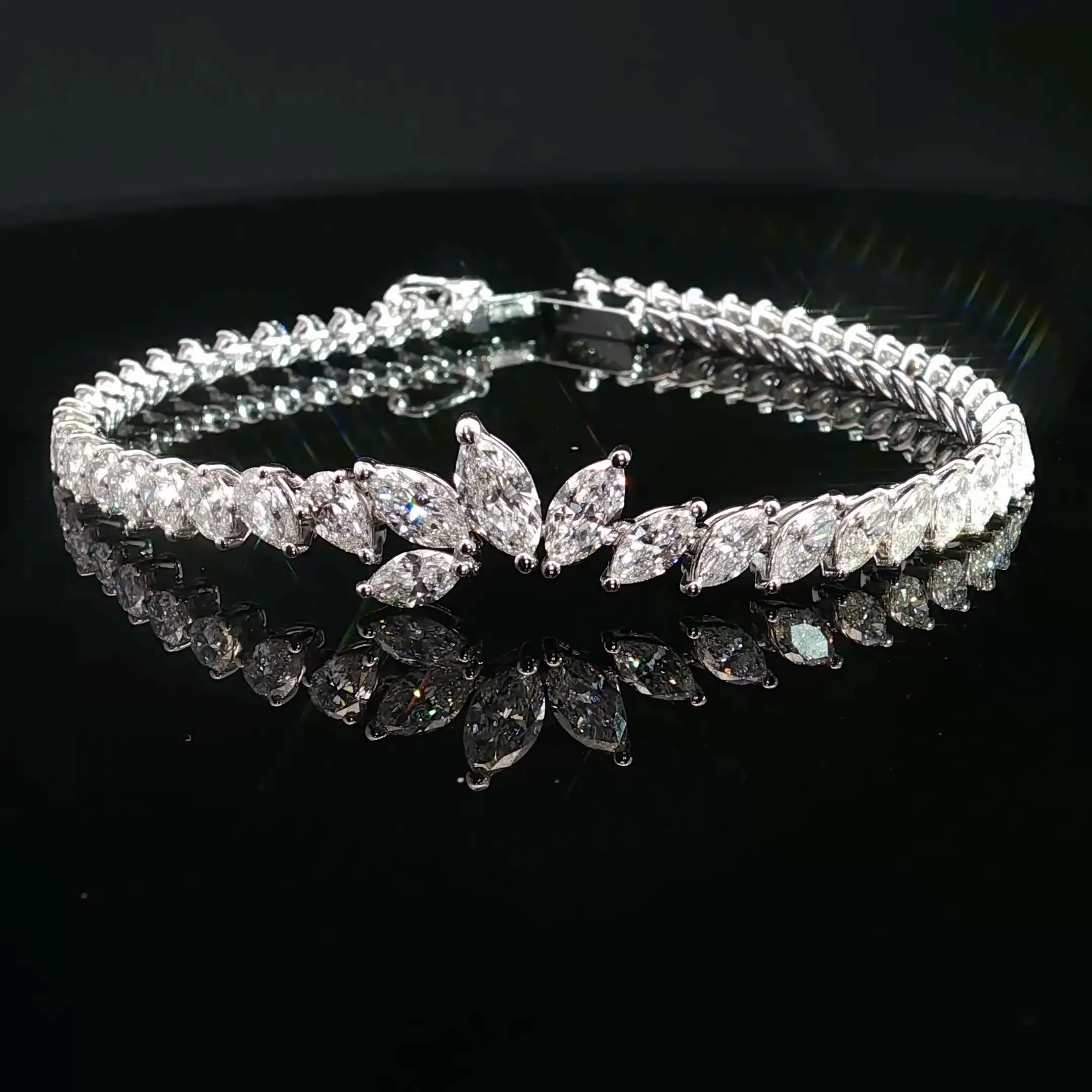 Close-up of three front and center sparkling diamond bracelet displayed on a black background.