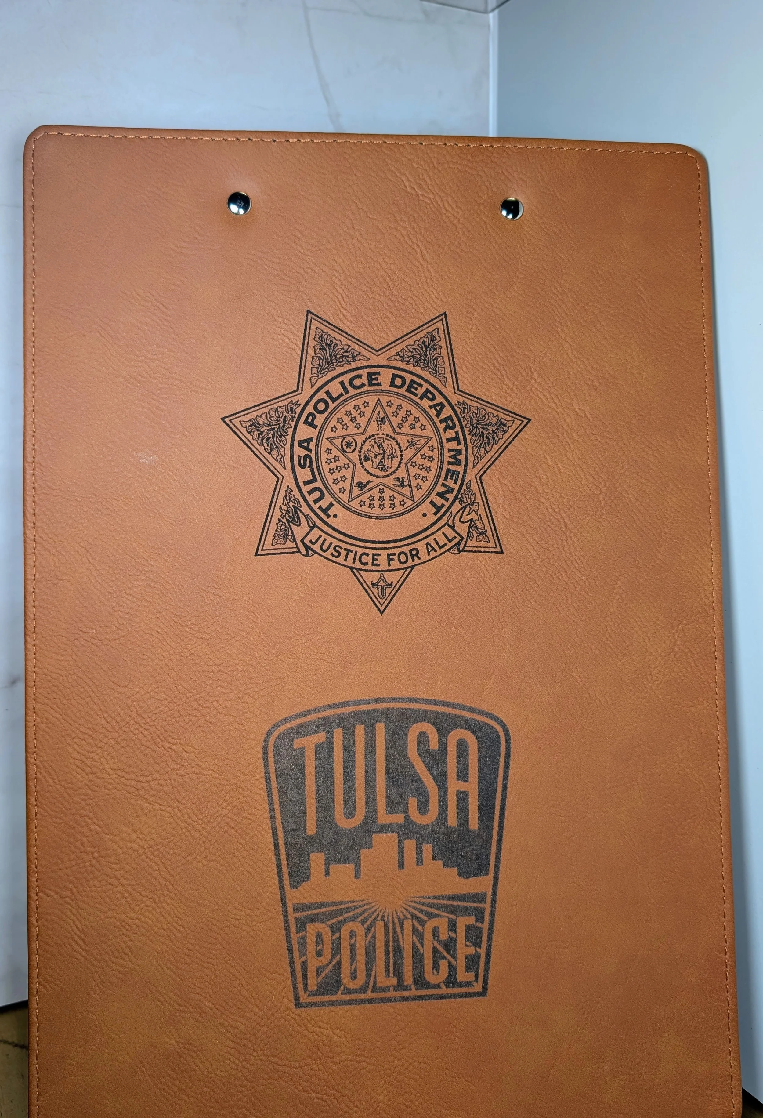 Orange folder with the Tulsa Police logo and the Texas Police Department badge with the slogan 'Justice for All' printed on it.