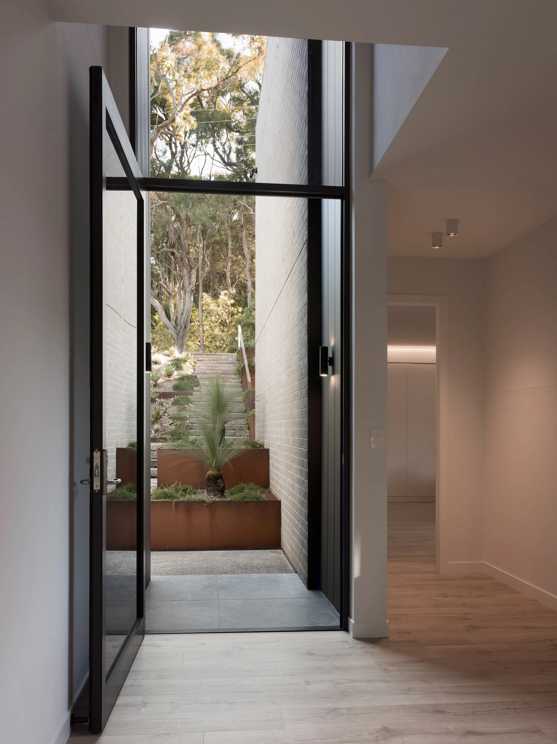 Glass front entry door, oak floors monument metal cladding
