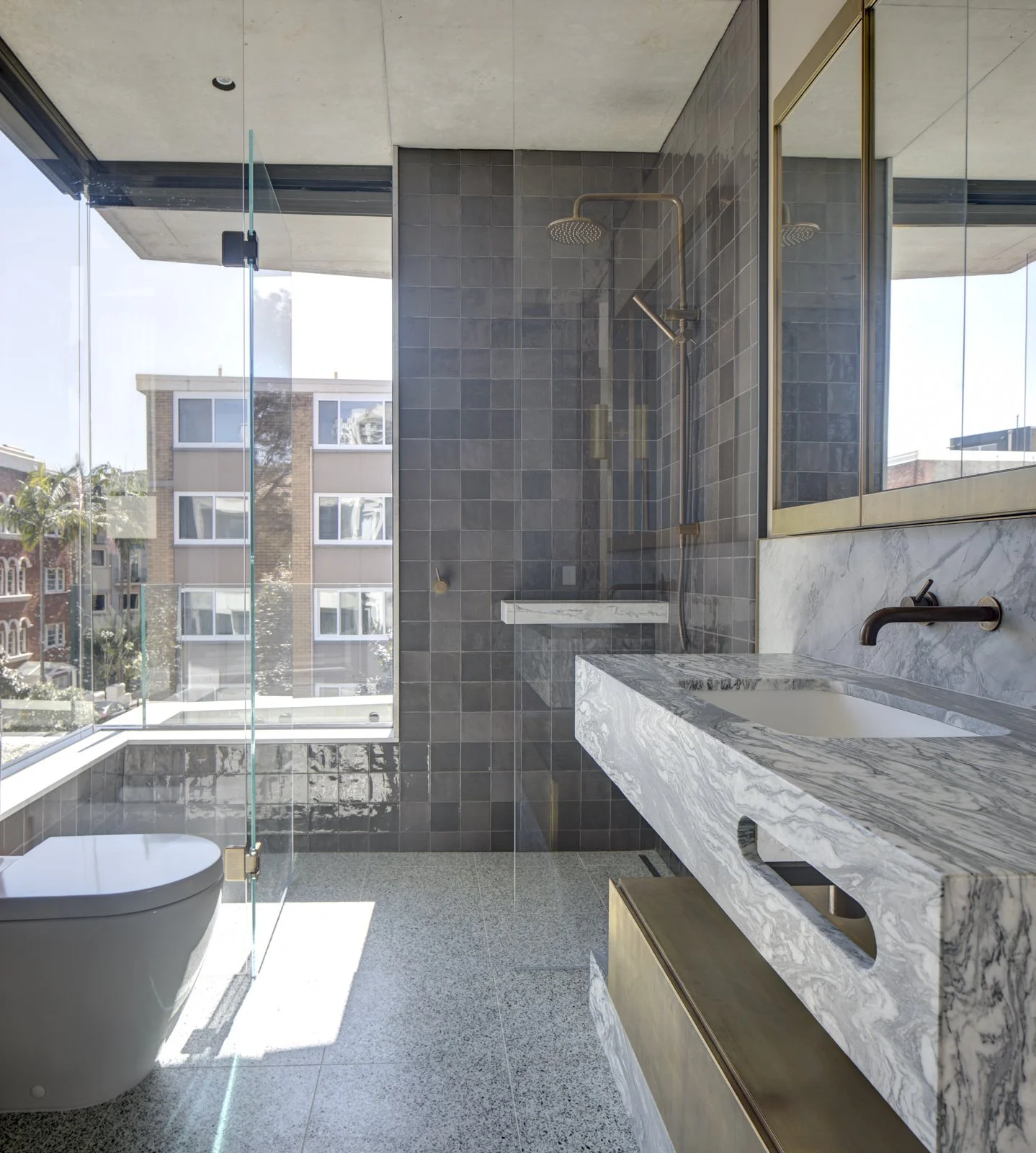 bathroom hand made tiles with window in the shower, Mable vanity and aged brass accessories