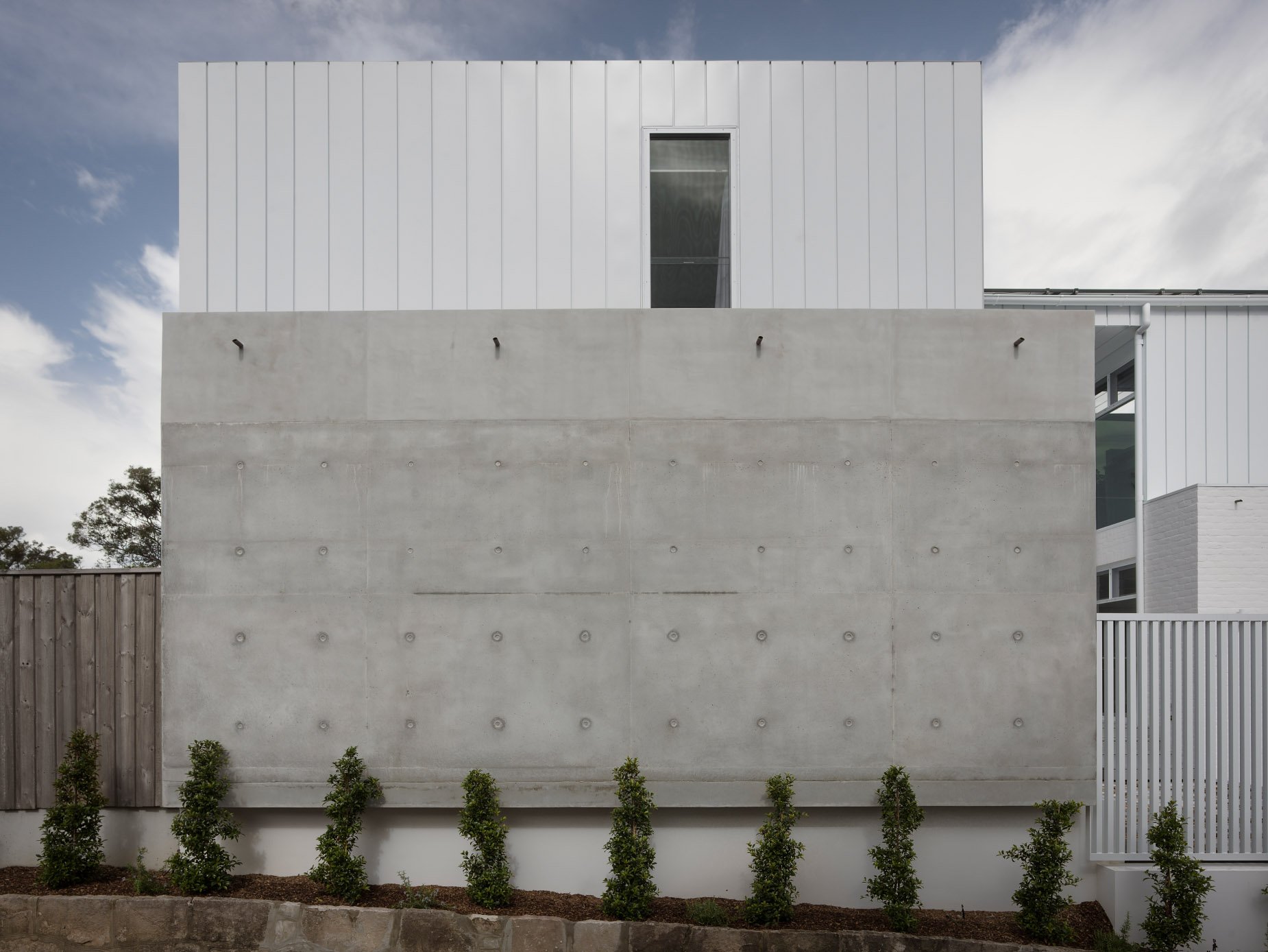 off form concrete, white metal cladding colour bond custom home