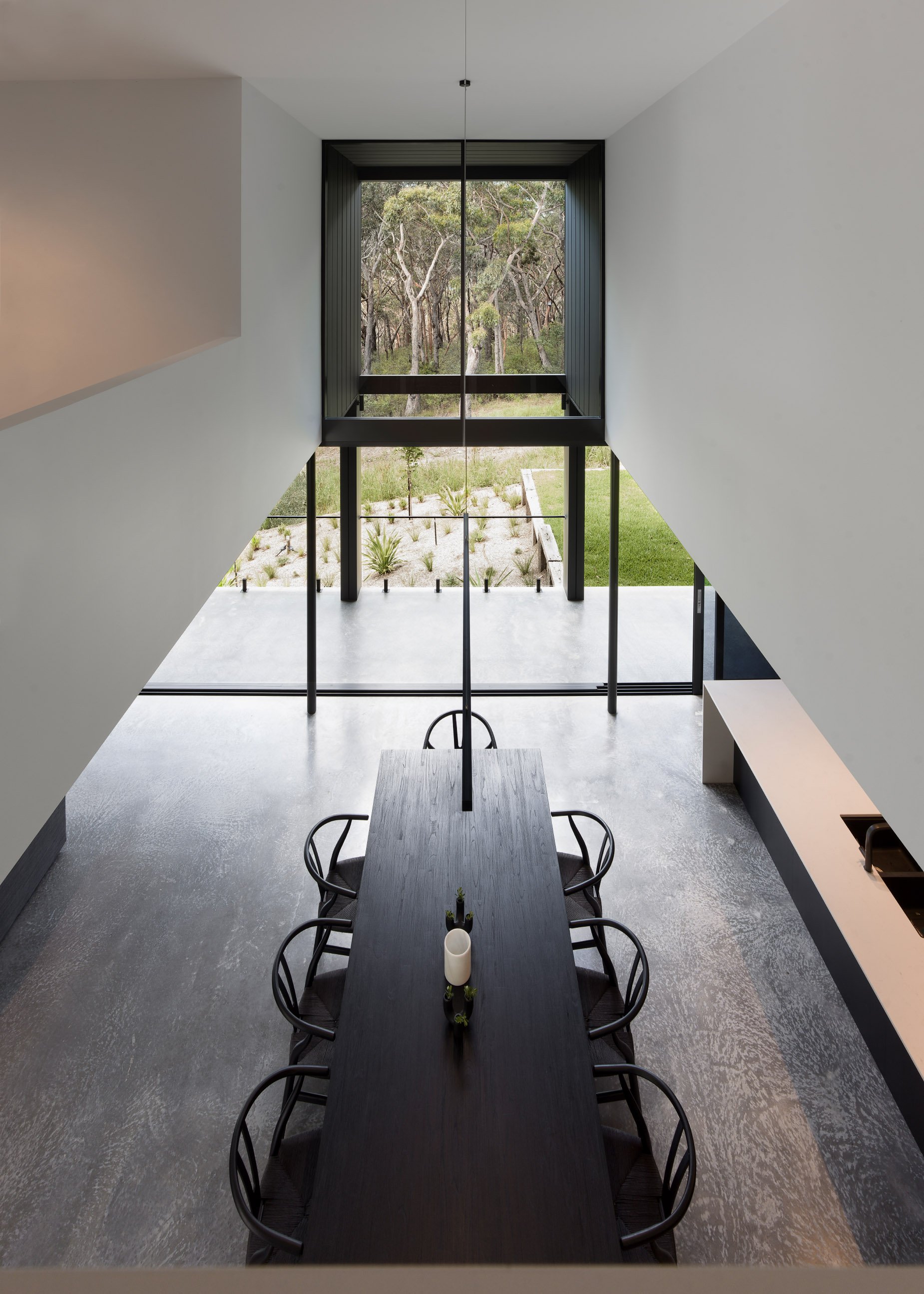 ceiling void, pendant light over kitchen table, burnished concrete floor, concrete