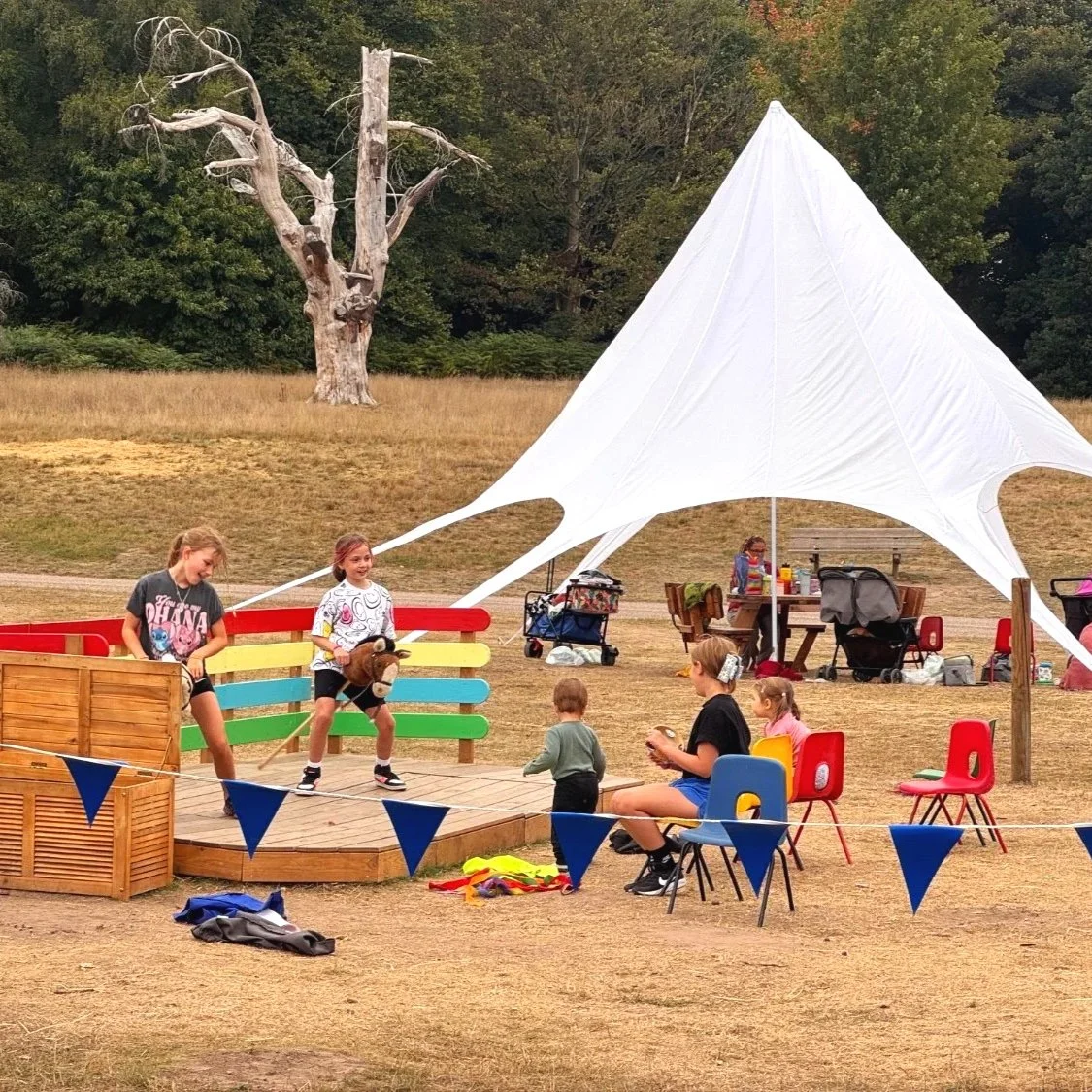 Children play on hobby horses at Clumber during Summer of Play.