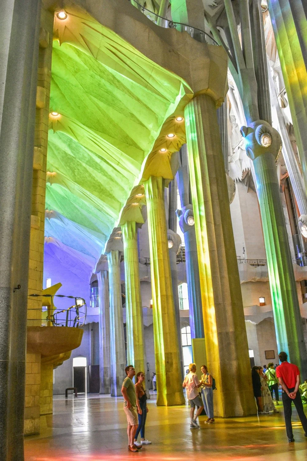 Visitors stand beneath an archway inside the Sagrada Familia in Barcelona.