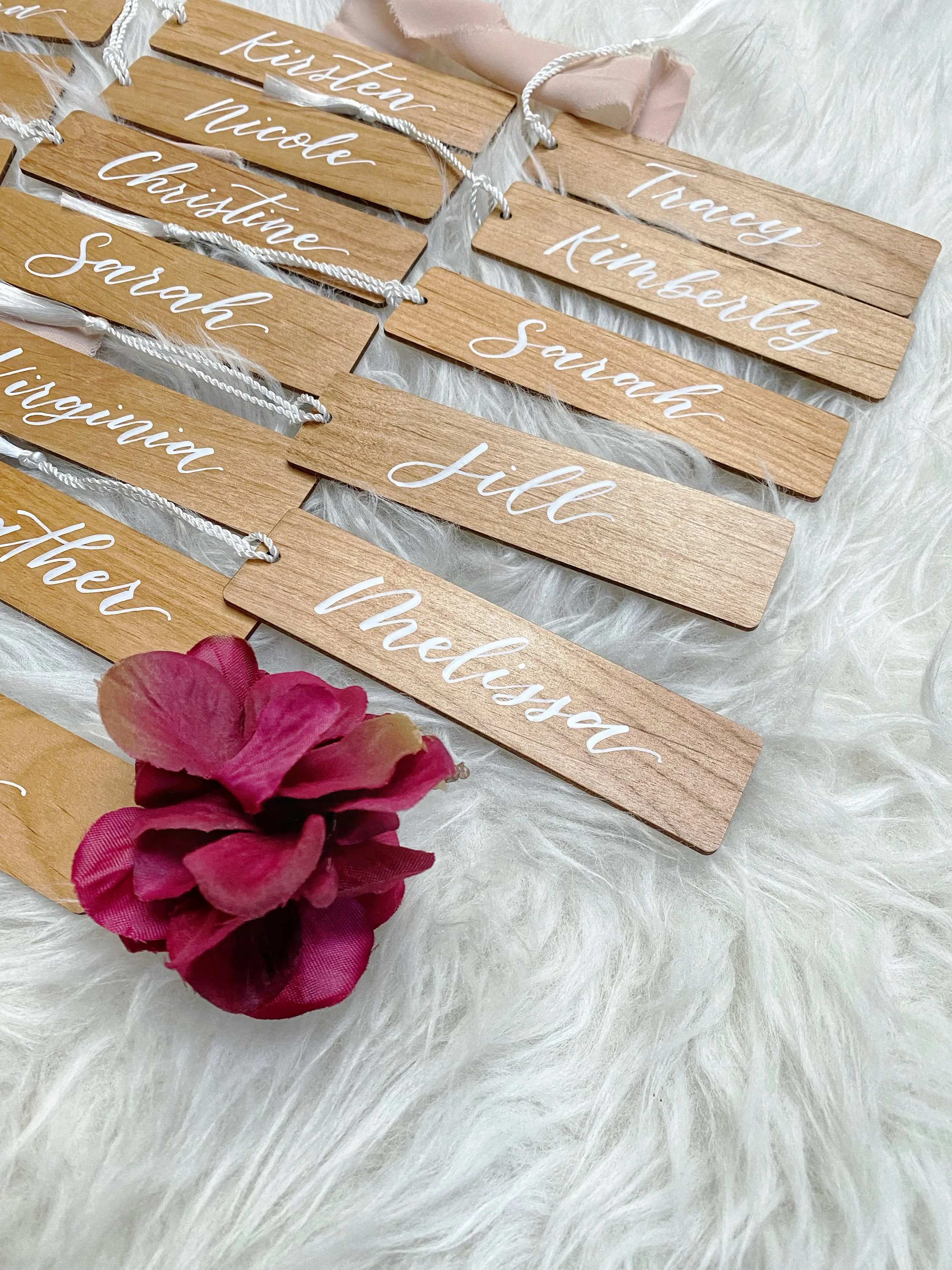 Personalized wooden bookmarks hand lettered with calligraphy, designed in studio for weddings, celebrations, and meaningful gifts.