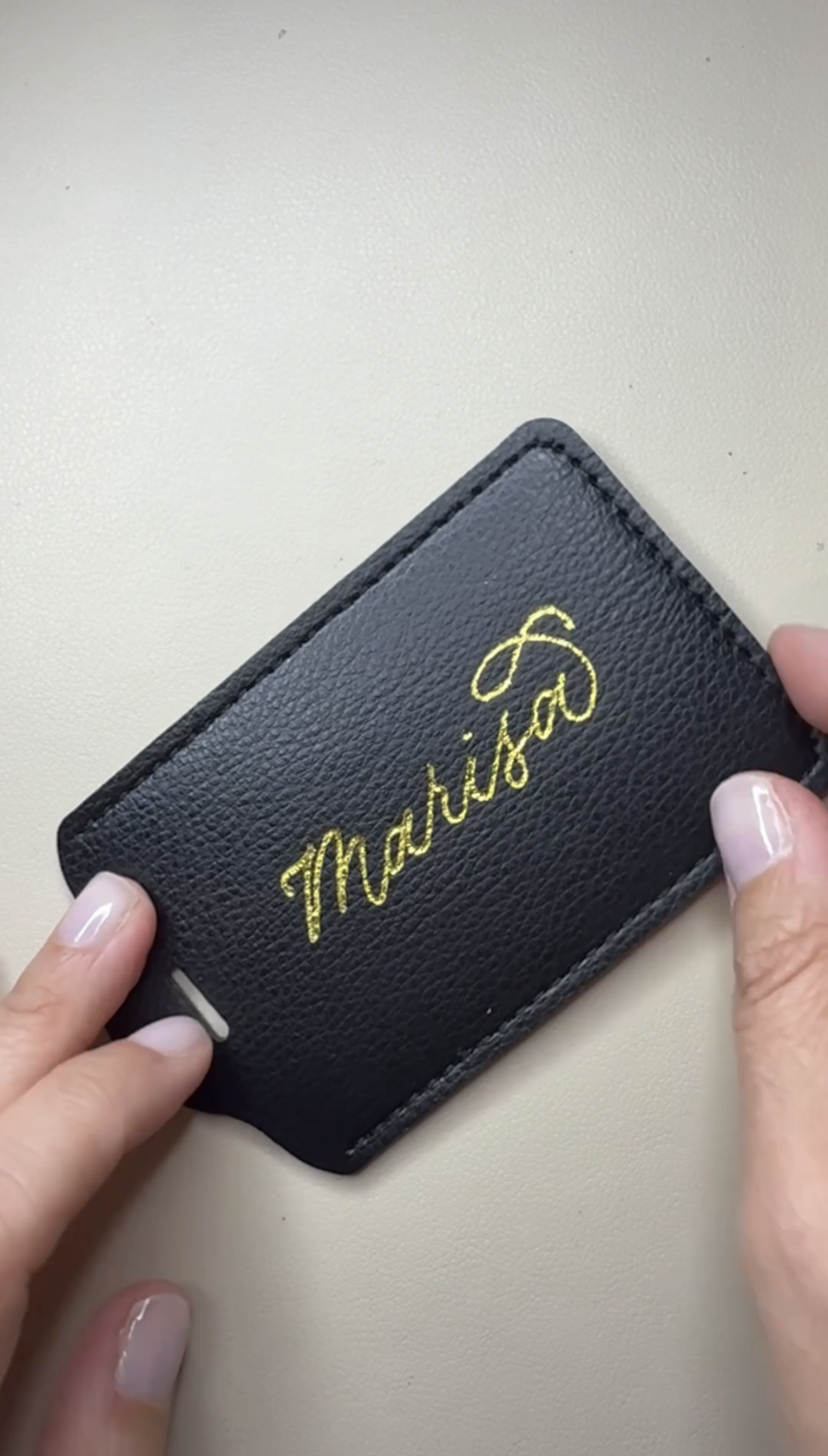Gold hot foil personalized luggage tag on black leather, designed for elevated corporate gifting and branded events.
