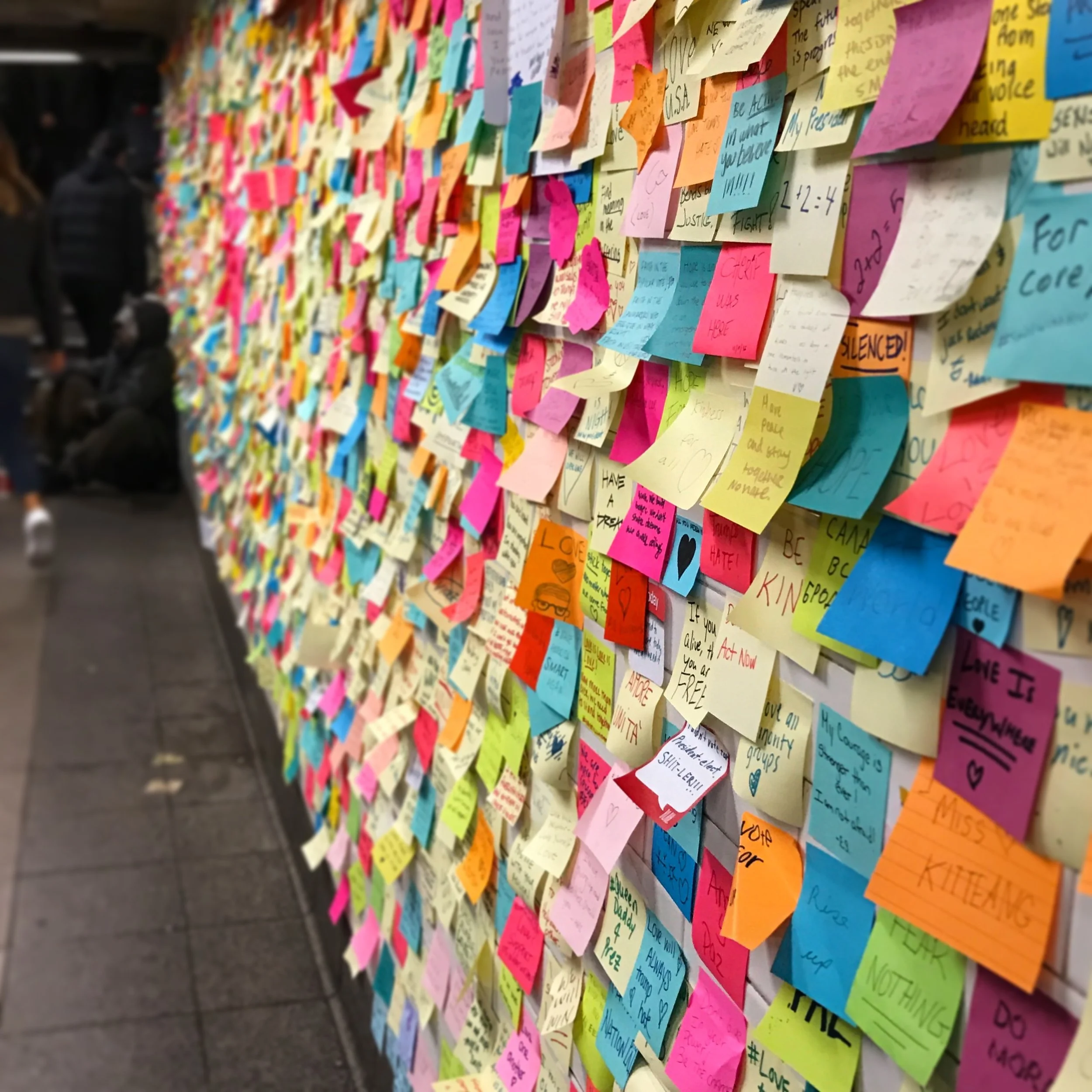 New York City subway wall covered with notes of inspiration, hope and strength. Kaity Kwock is a calligrapher and engraver based in New Jersey, who is guided by her responsibility to community and inclusiveness in her work.