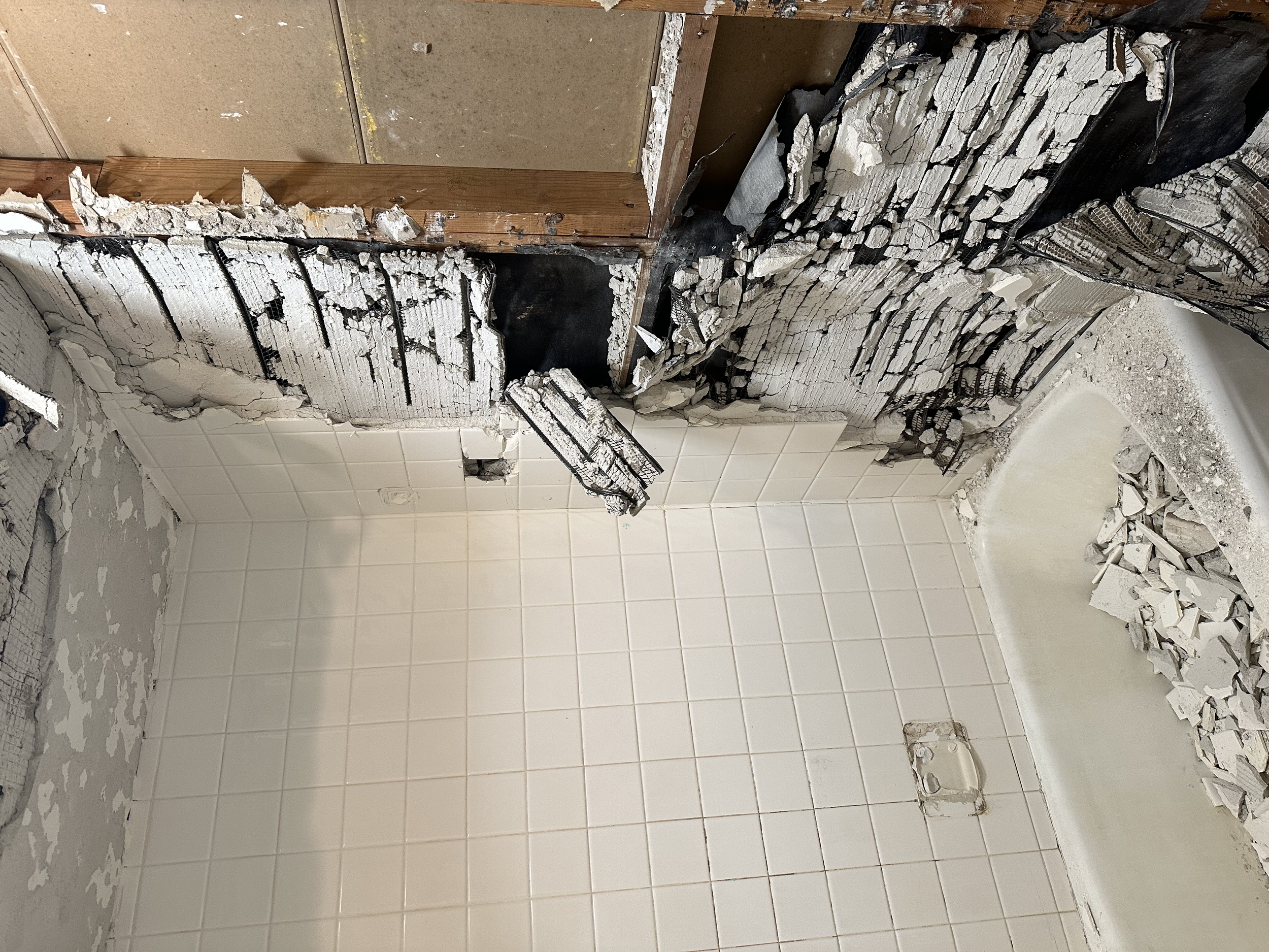 We started to tear down the tile and as you can see it was built to last. Wire lathing and felt paper behind to block moisture. 