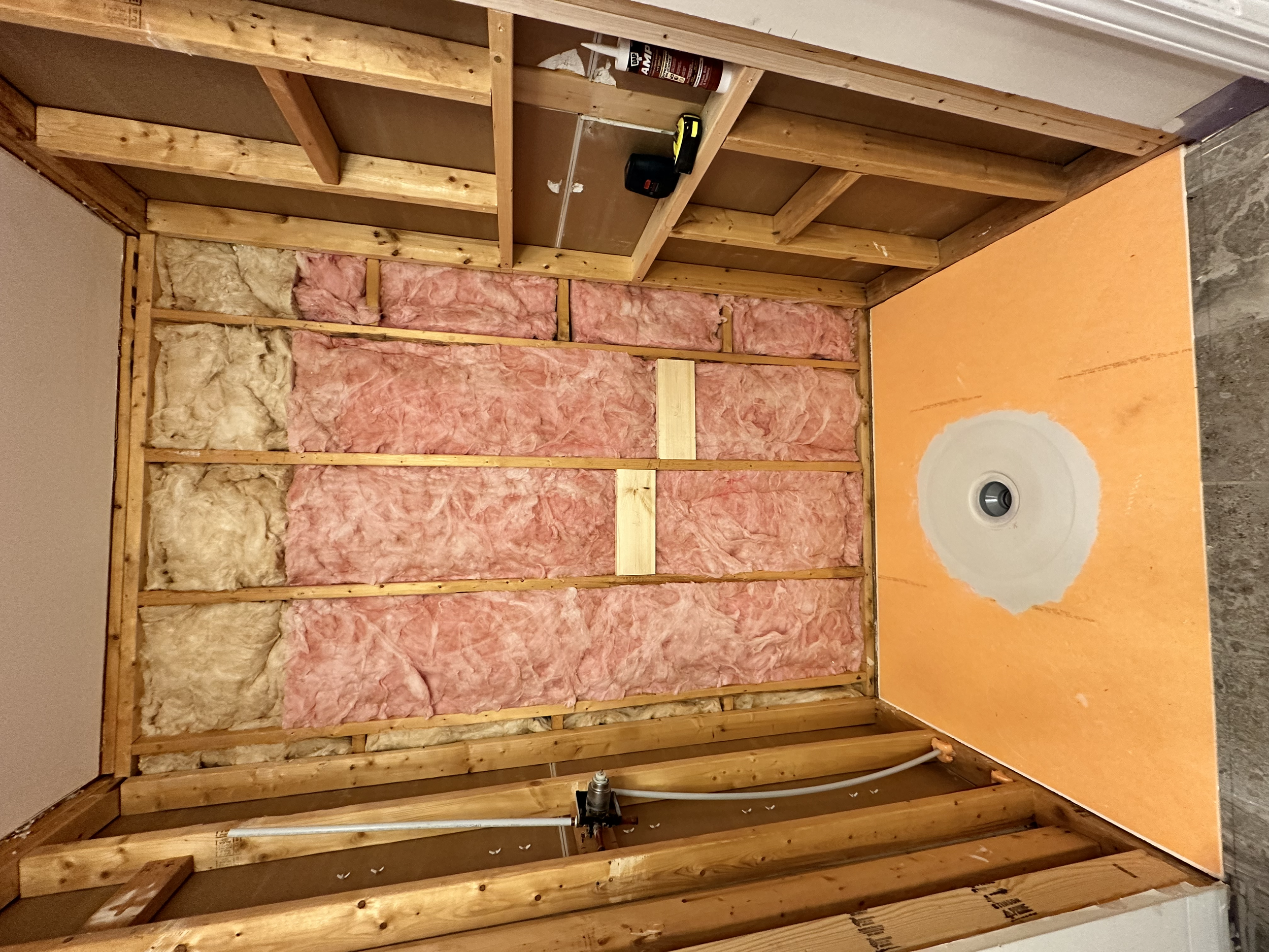 After stripping down the walls we used a Schluter shower pan for our base.