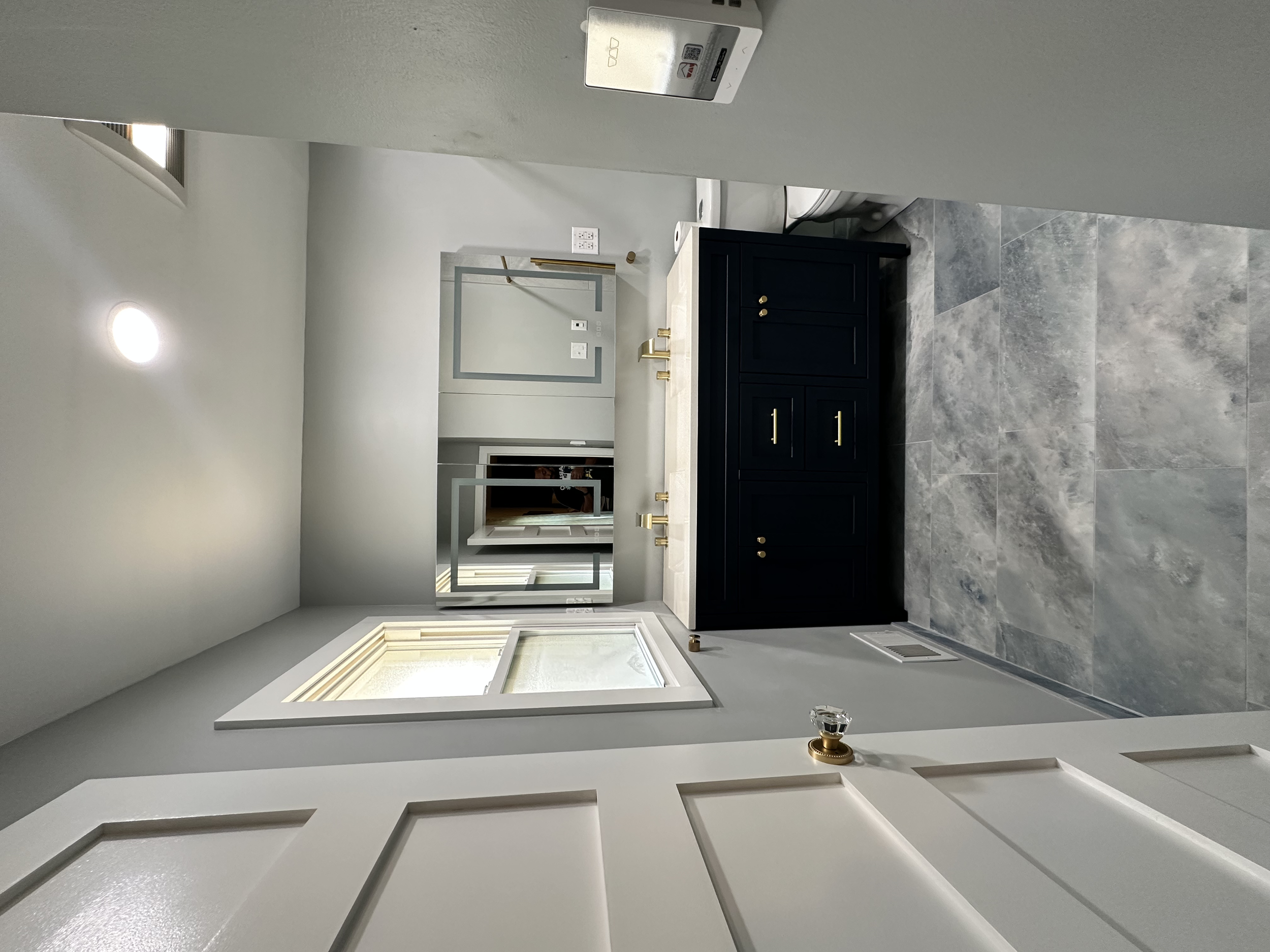 The window was replaced in this bathroom and the mirror had anti-fog capabilities and three different lighting temperatures.