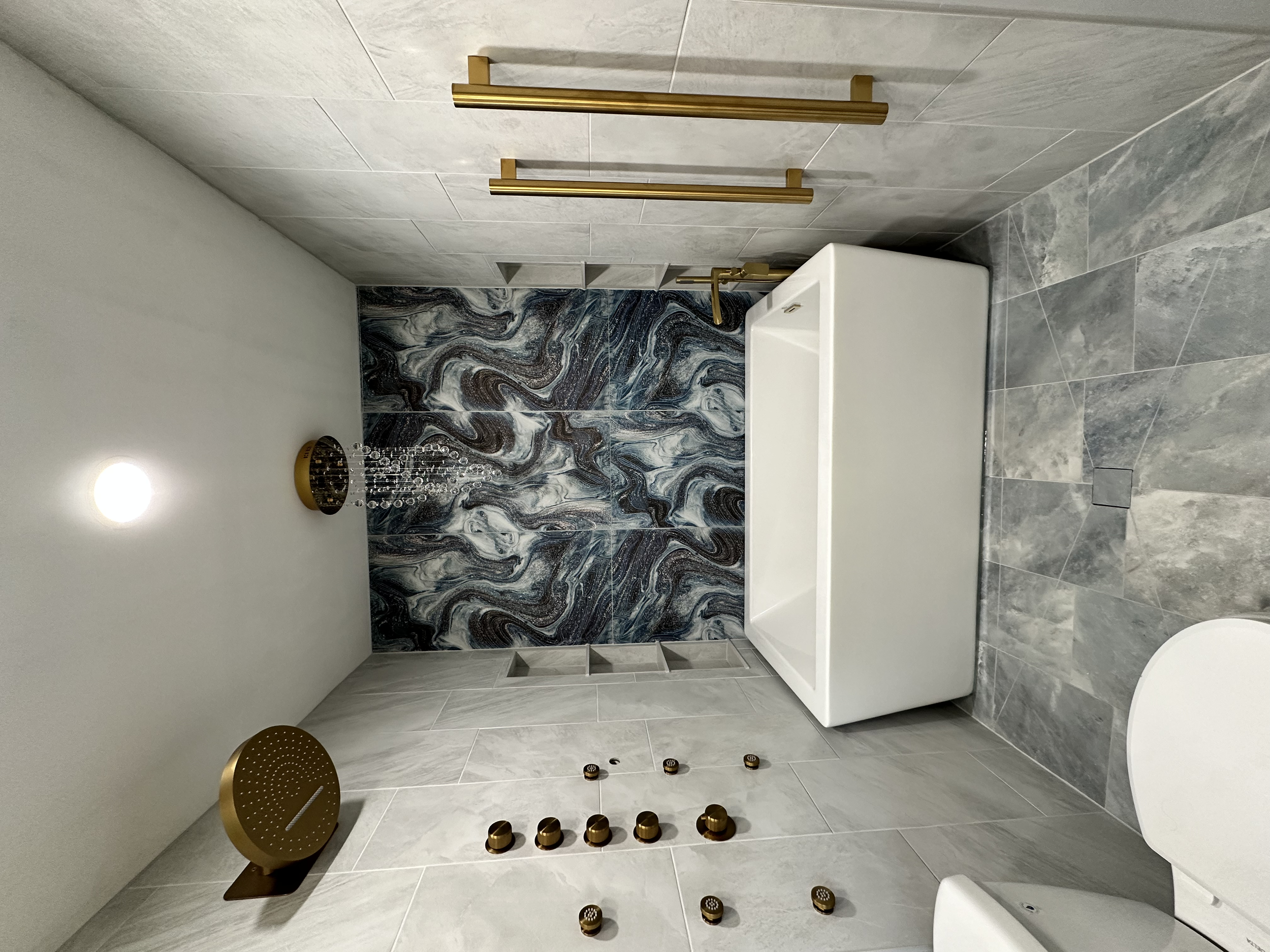 The chandelier over the soaking tub added a luxurious touch to this bathroom. The towel bars installed on the wall to the right are heated.