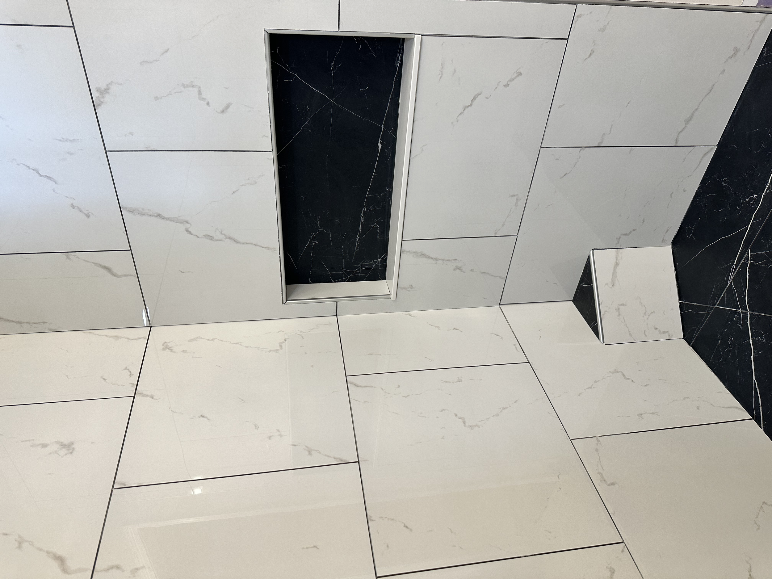 Shower niche installed and the customer requested a small corner foot rest.