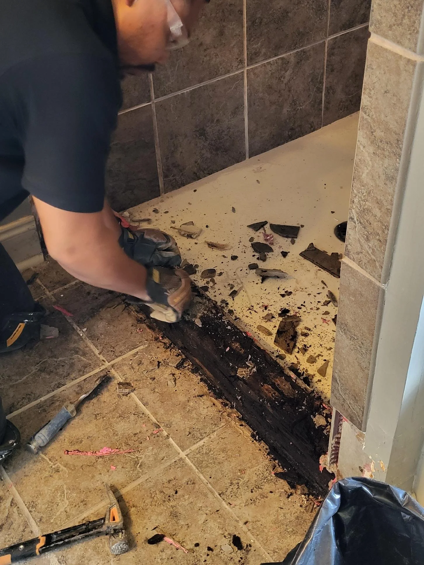 The framing of the shower curb was almost completely rotted which made demolition fairly easy.