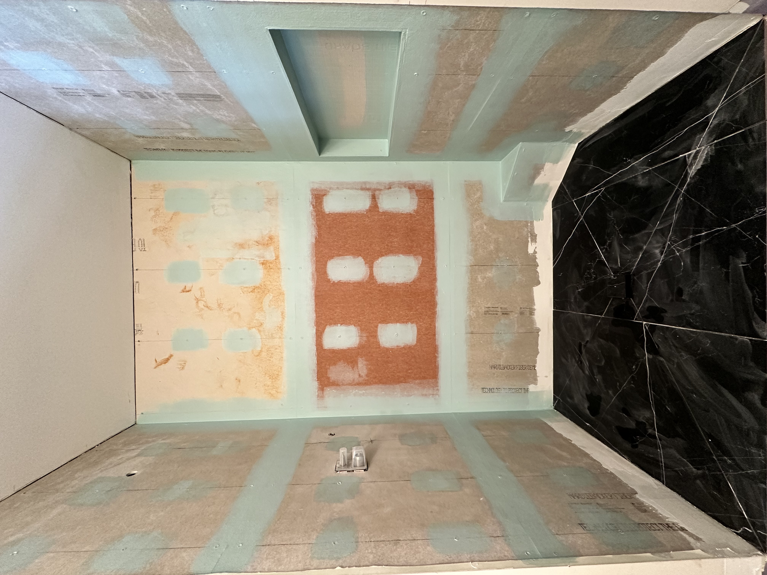 We used HardiBacker cement board and Mapei AquaDefense waterproofing membrane.