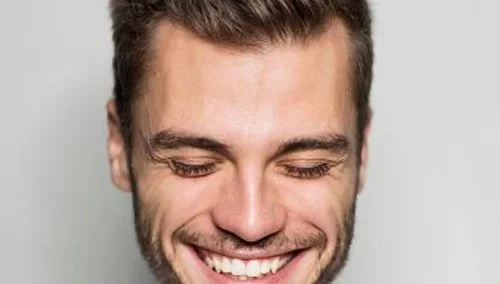 Smiling man representing hair restoration and hair loss treatment services in Ottawa