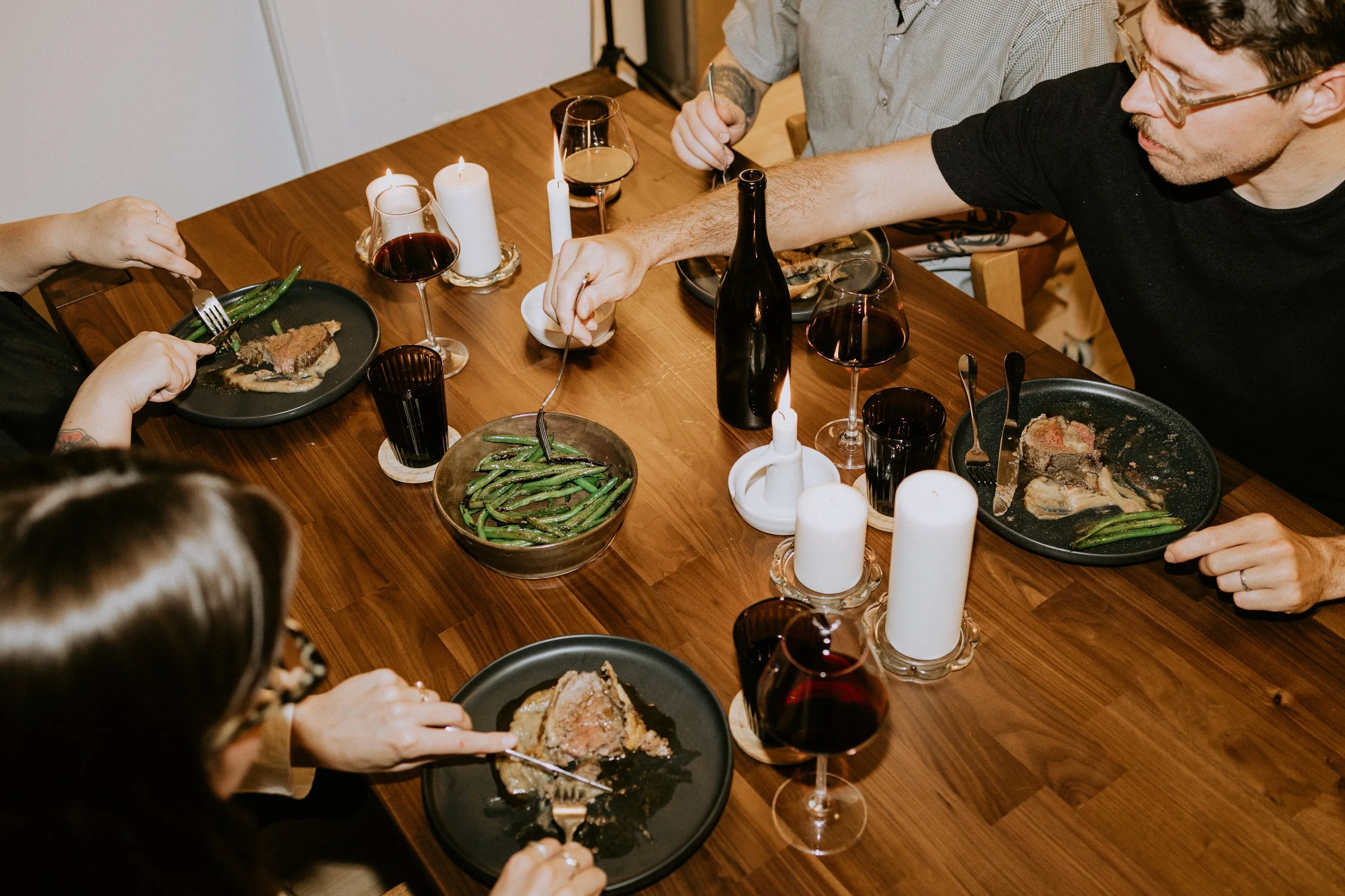 Four people in Winnipeg enjoying a private dining experience including local produce, beef wellington, and rare wines