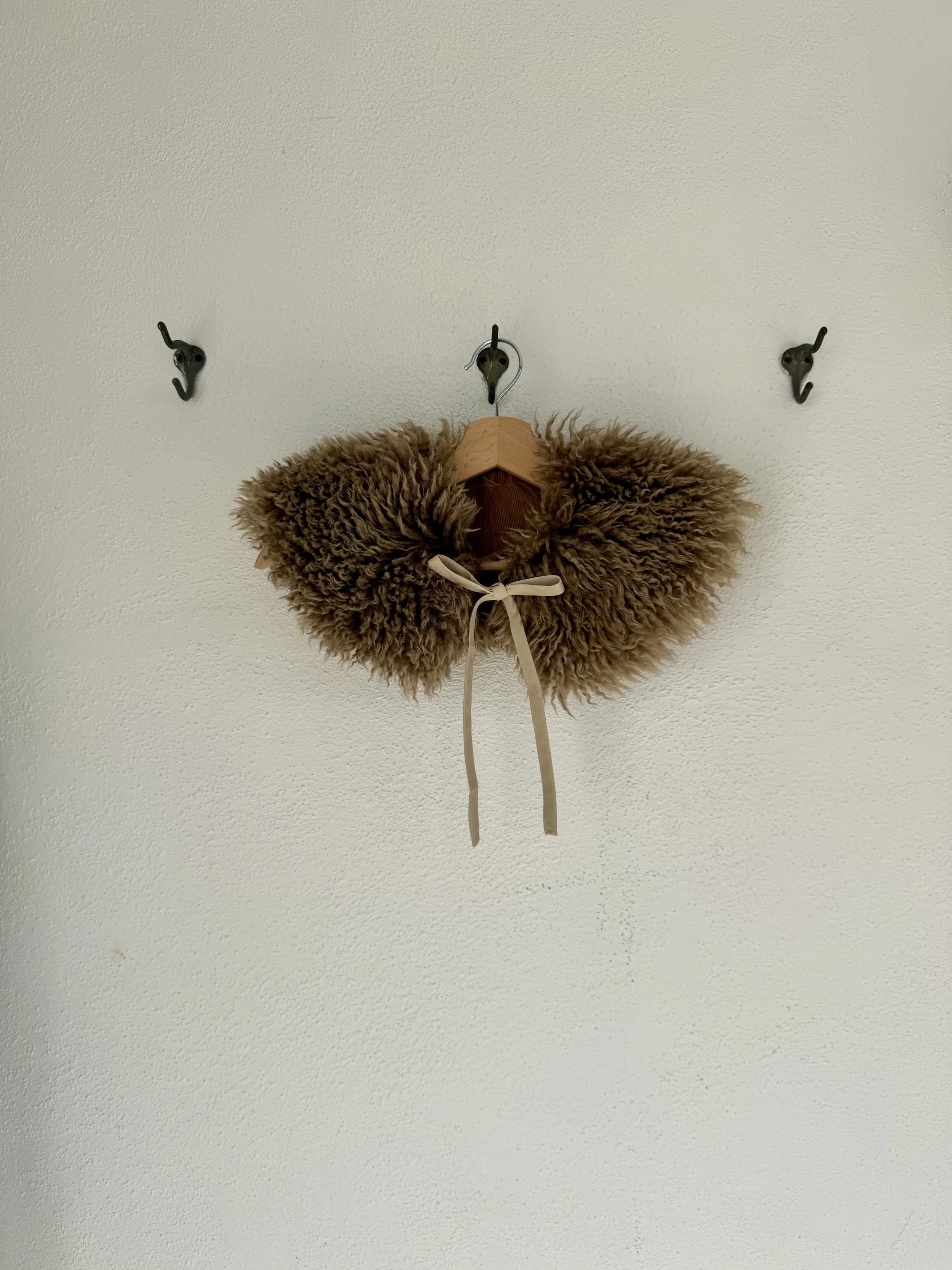 Sheepskin collar: this cozy luxurious collar can be lined in any fabric and has ties to elevate any outfit. It is the perfect shape and addition to the Field Coat!