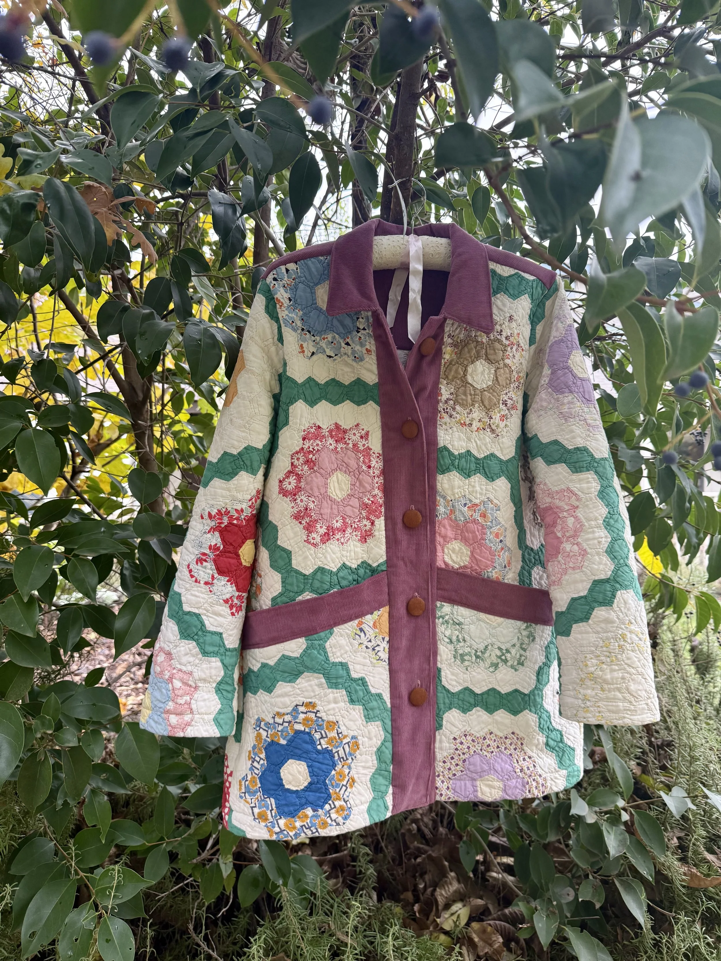 Orchard Coat: this collared coat has accented front plackets and deep lined pockets. It hits past the hips with button or snap closures.