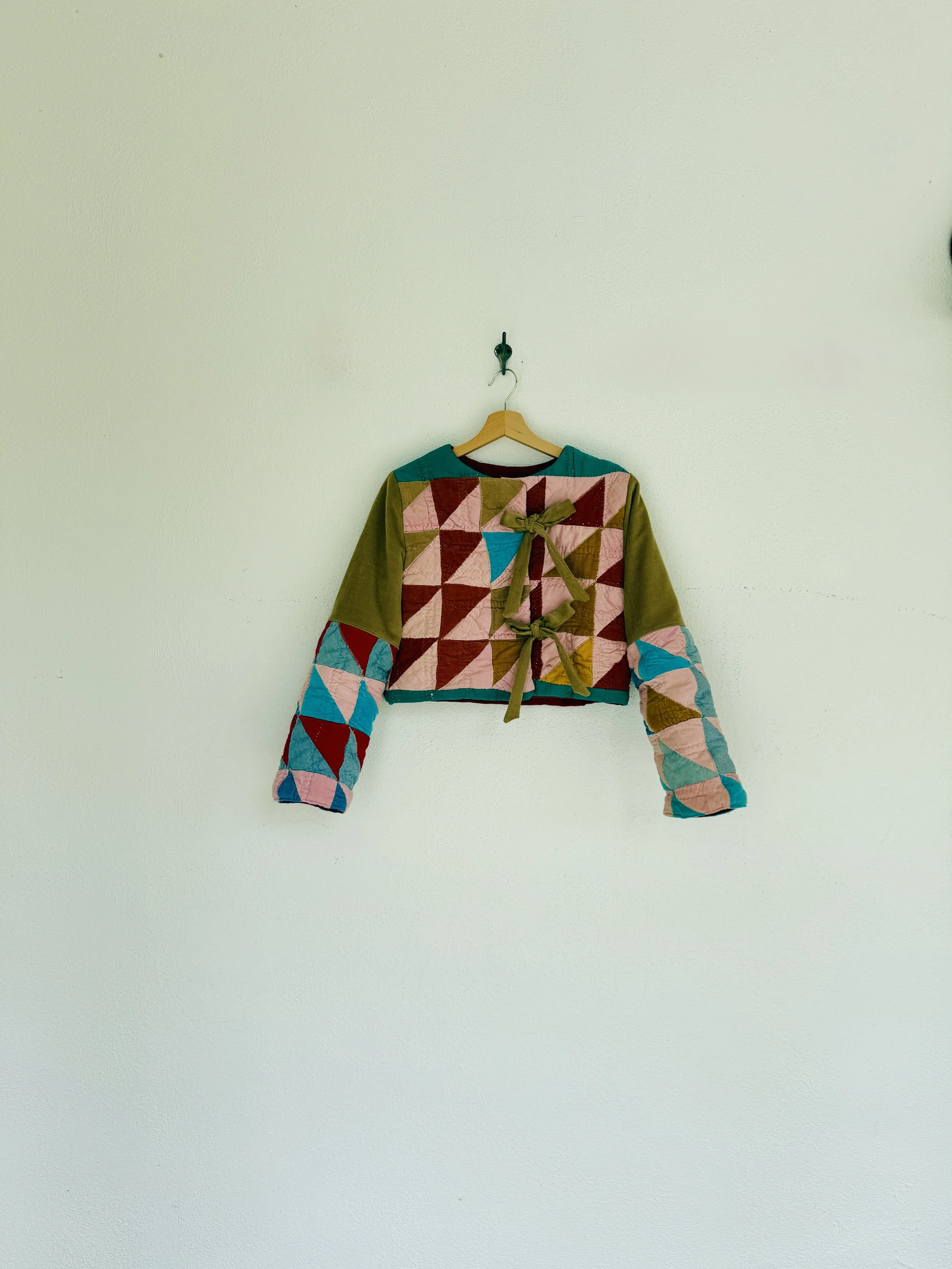 Field Coat: this coat has a fitted, cropped silhouette and a secret pocket inside, can have snap, button or tie closures. A tie on sheepskin collar is a great addition to this cute cropped coat!