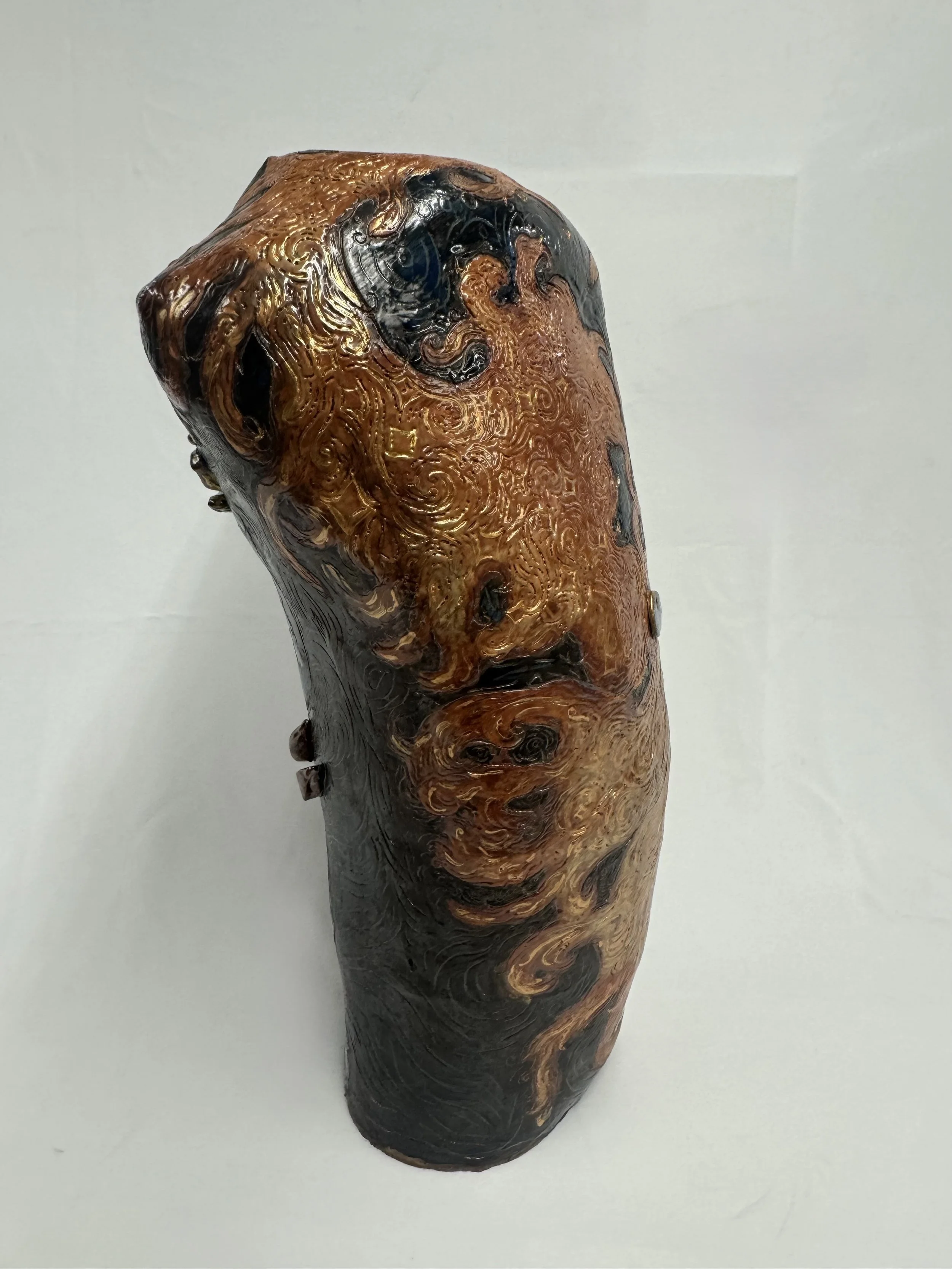 “Reborn Again”, 2025. Red stoneware clay with sgraffitto,  black and porcelain slips, malcolm shino, red irwing, peach bloom 2, cuba's beaches, purple haze, and gold acrylic paint.
9" x 23" inches 
